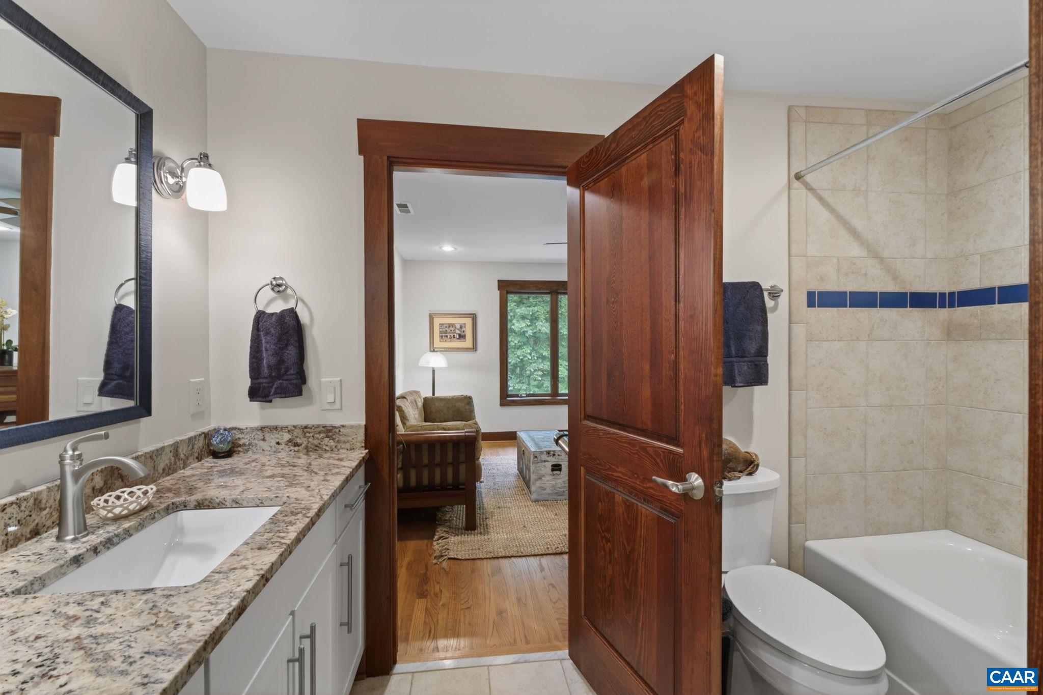 Upper level tiled bathroom with granite counter. Upper level tiled bathroom with granite counter.