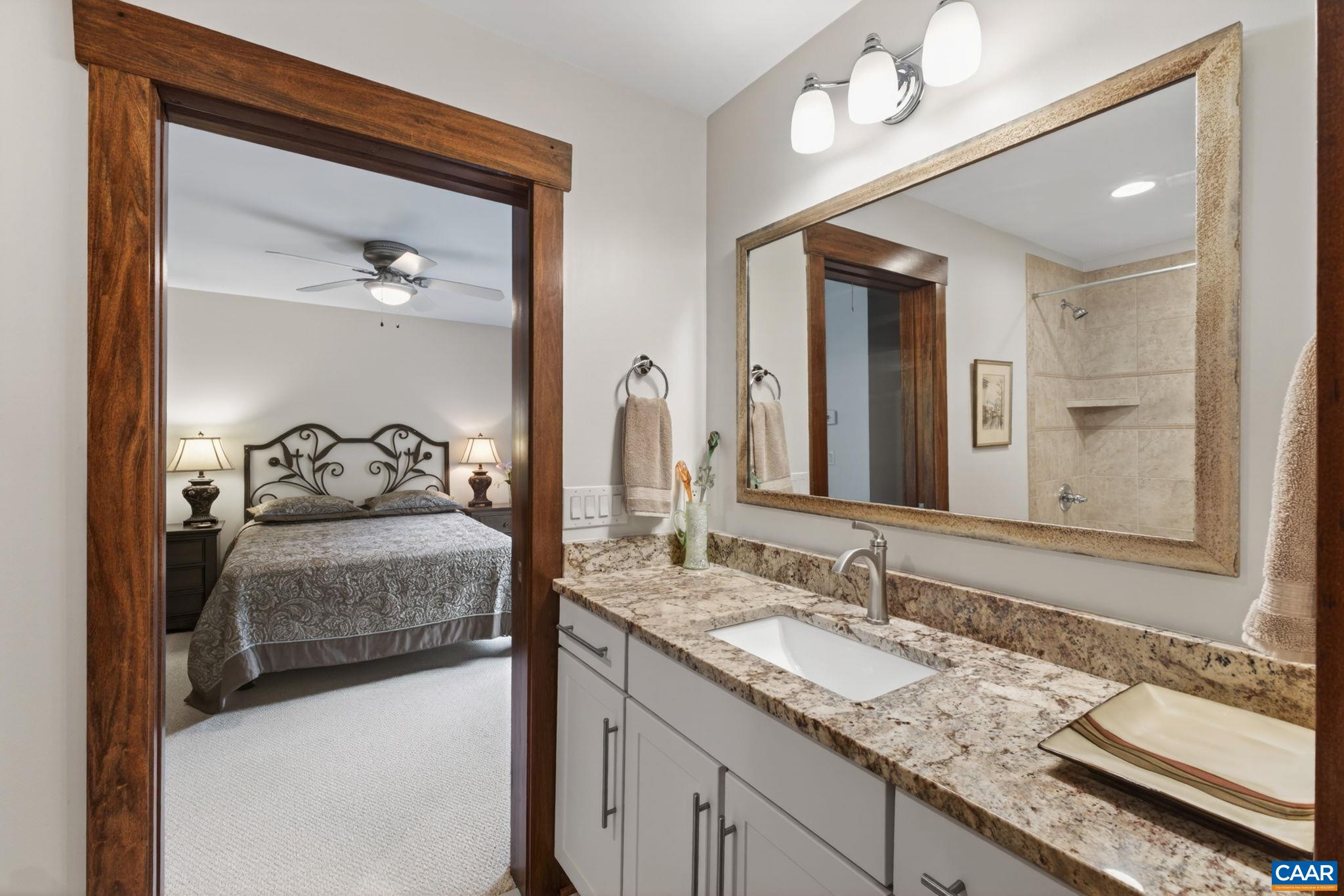 Upper level tiled bathroom with granite counter. Upper level tiled bathroom with granite counter.