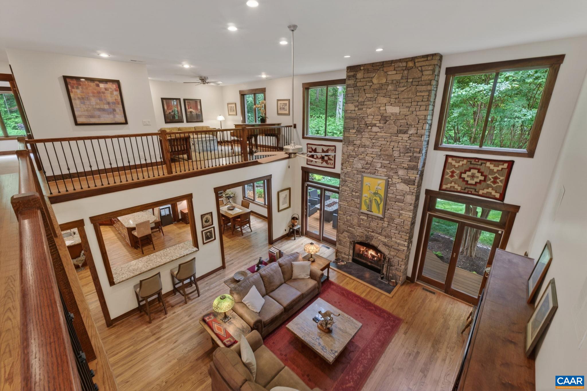 Second level walkway and loft overlook the great room. Second level walkway and loft overlook the great room.