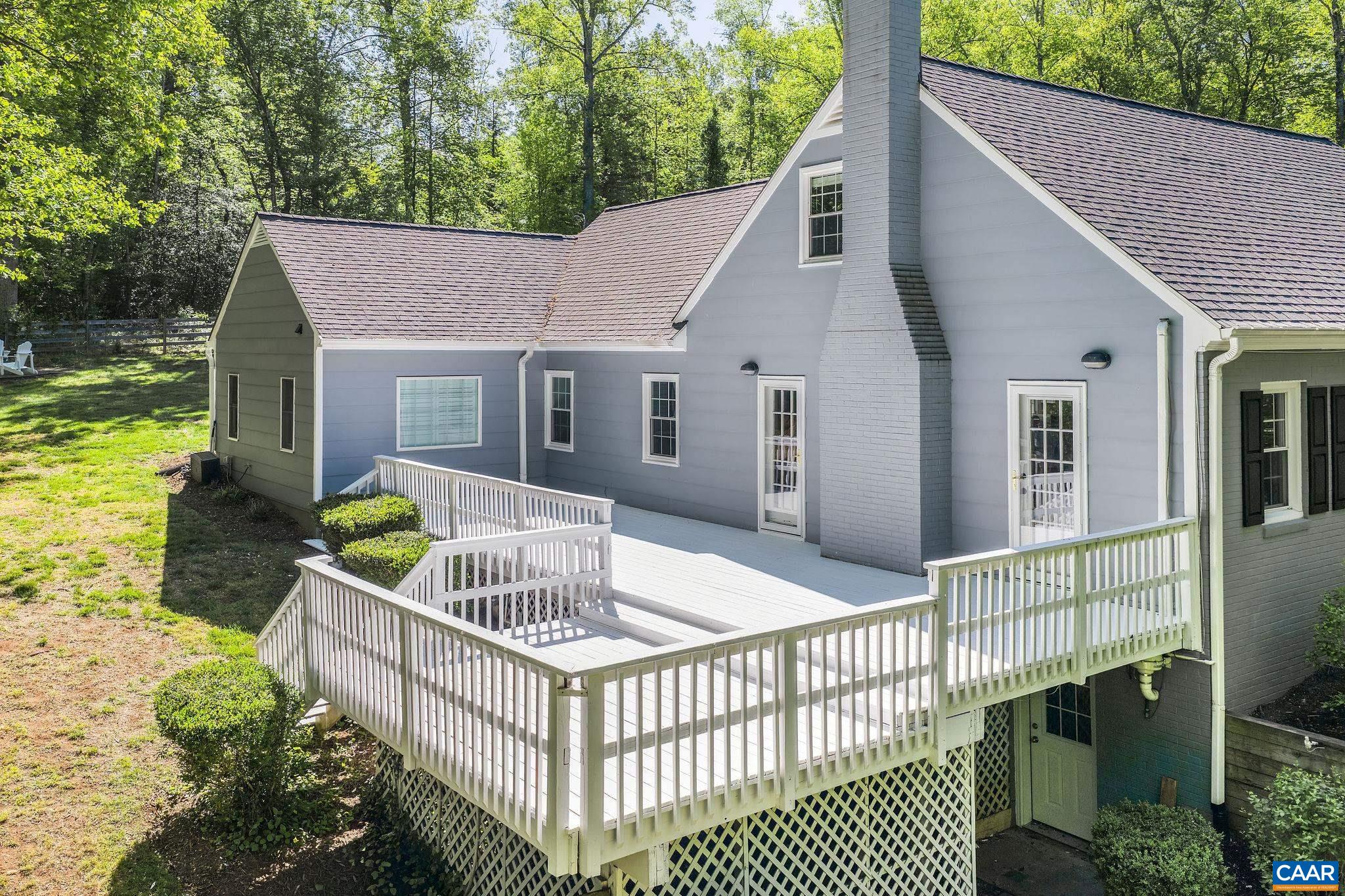 Expansive side deck off the living room offers even more gathering space.