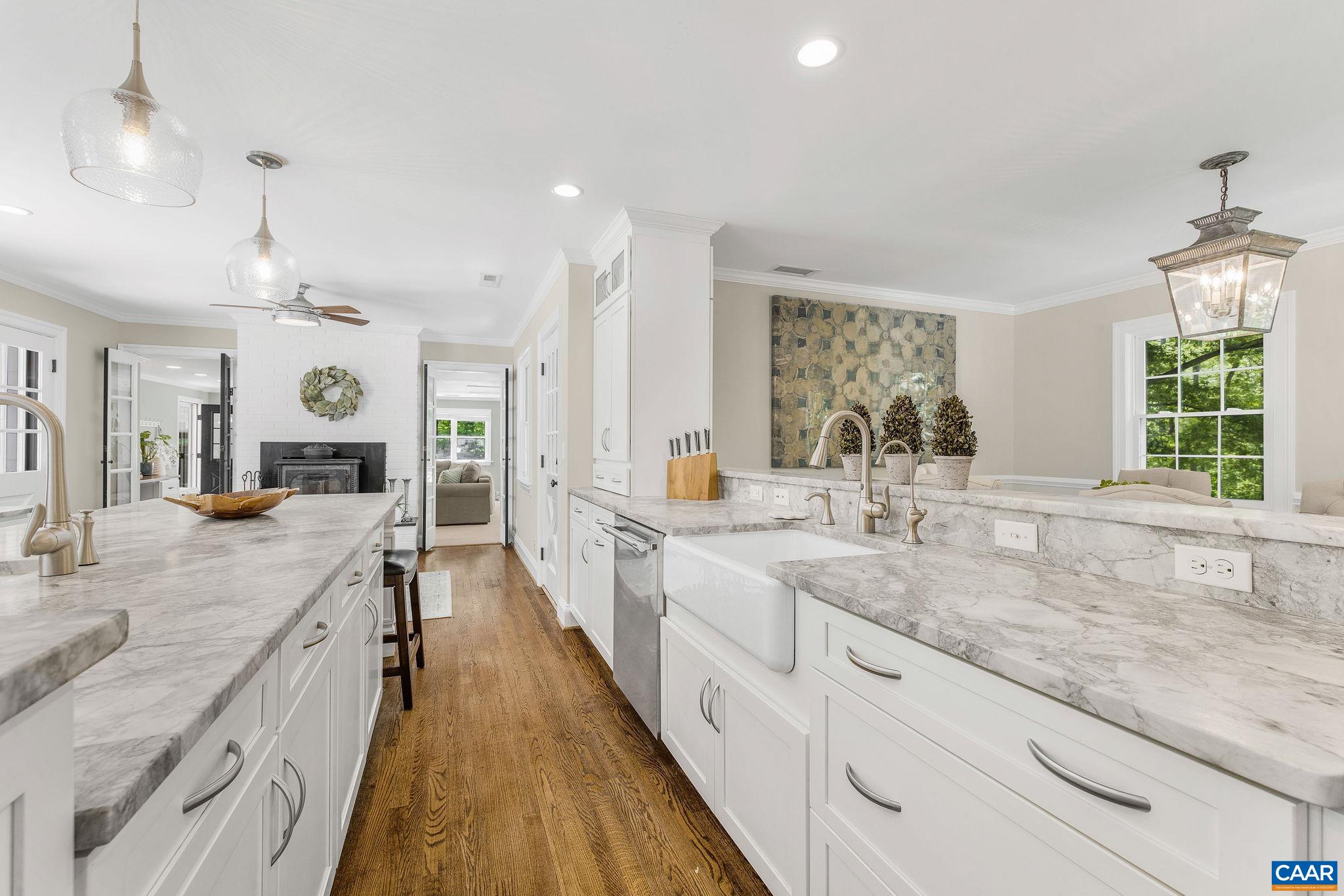 The large island features a second sink, along with copious storage and a breakfast bar.