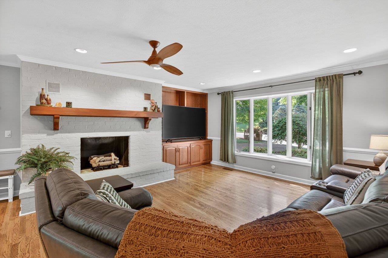 This spacious room off the kitchen features a brick fireplace , built-in cabinentry and a large picture window to bring in lots of natural light This spacious room off the kitchen features a brick fireplace , built-in cabinentry and a large picture window to bring in lots of natural light