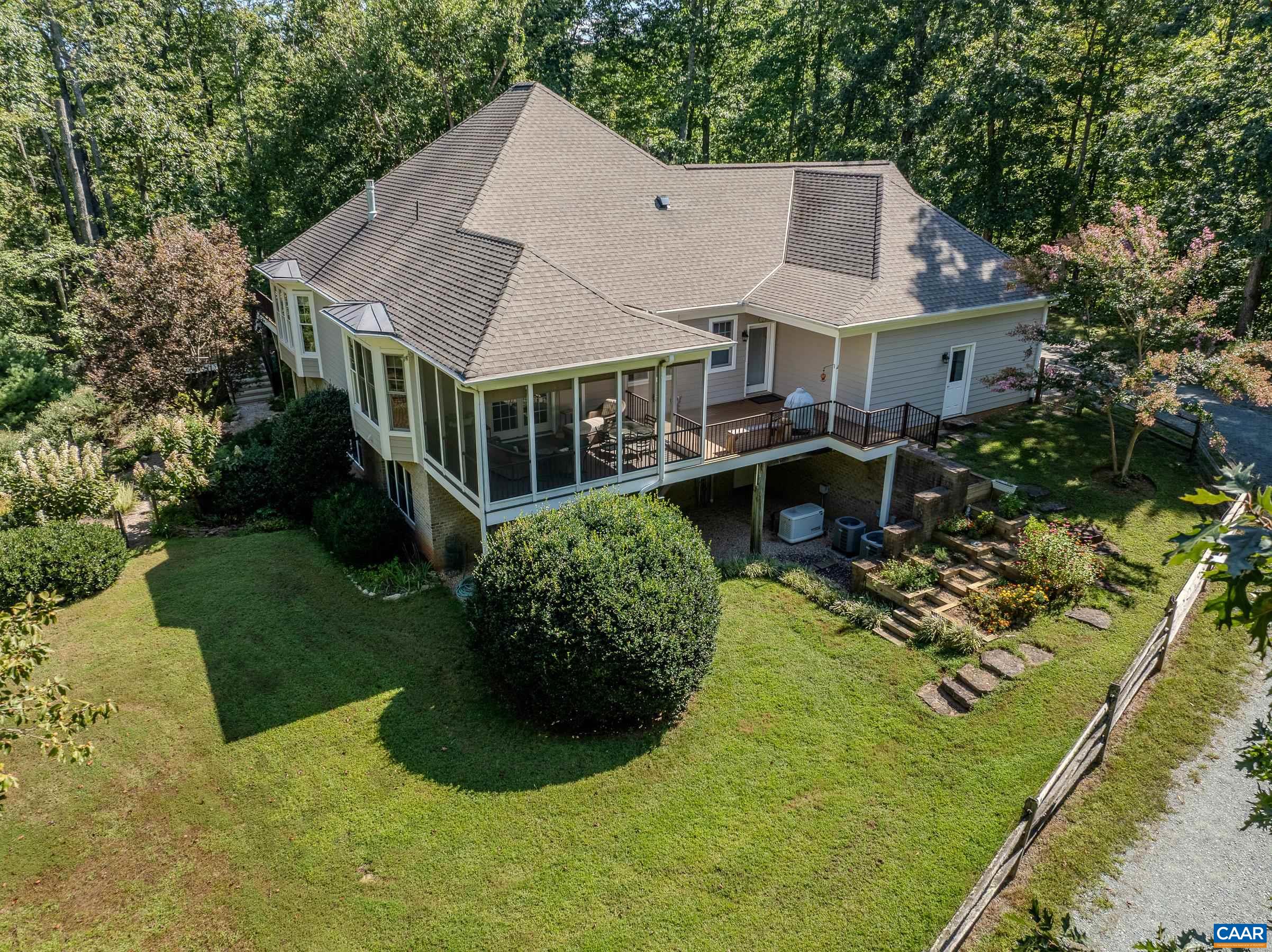 Beautiful custom home surrounded by woodlands offers private living minutes from Charlottesville and Crozet.