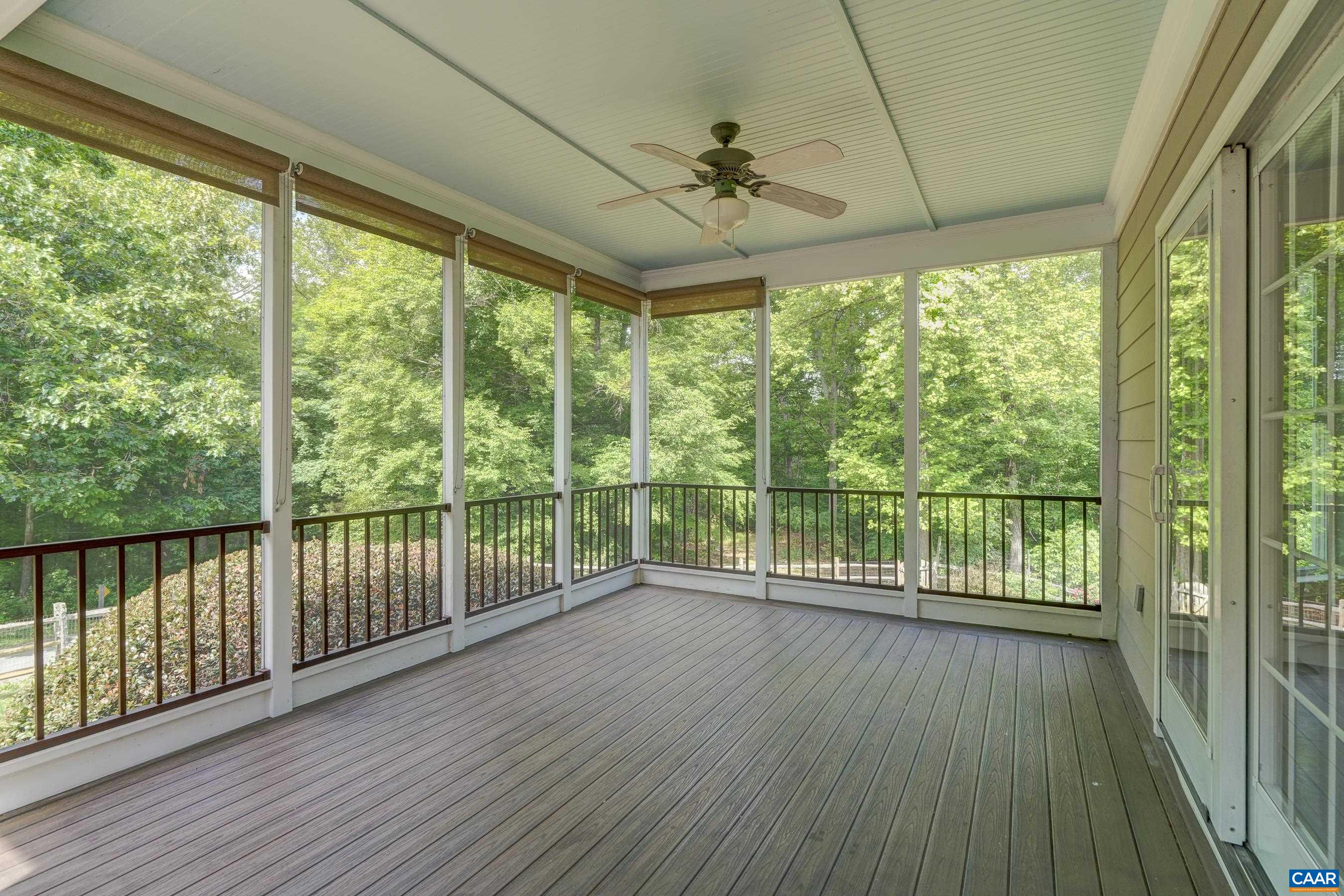 Incredible screened porch adjacent to the dining room features pull down roller shades and lets you enjoy the outdoors!