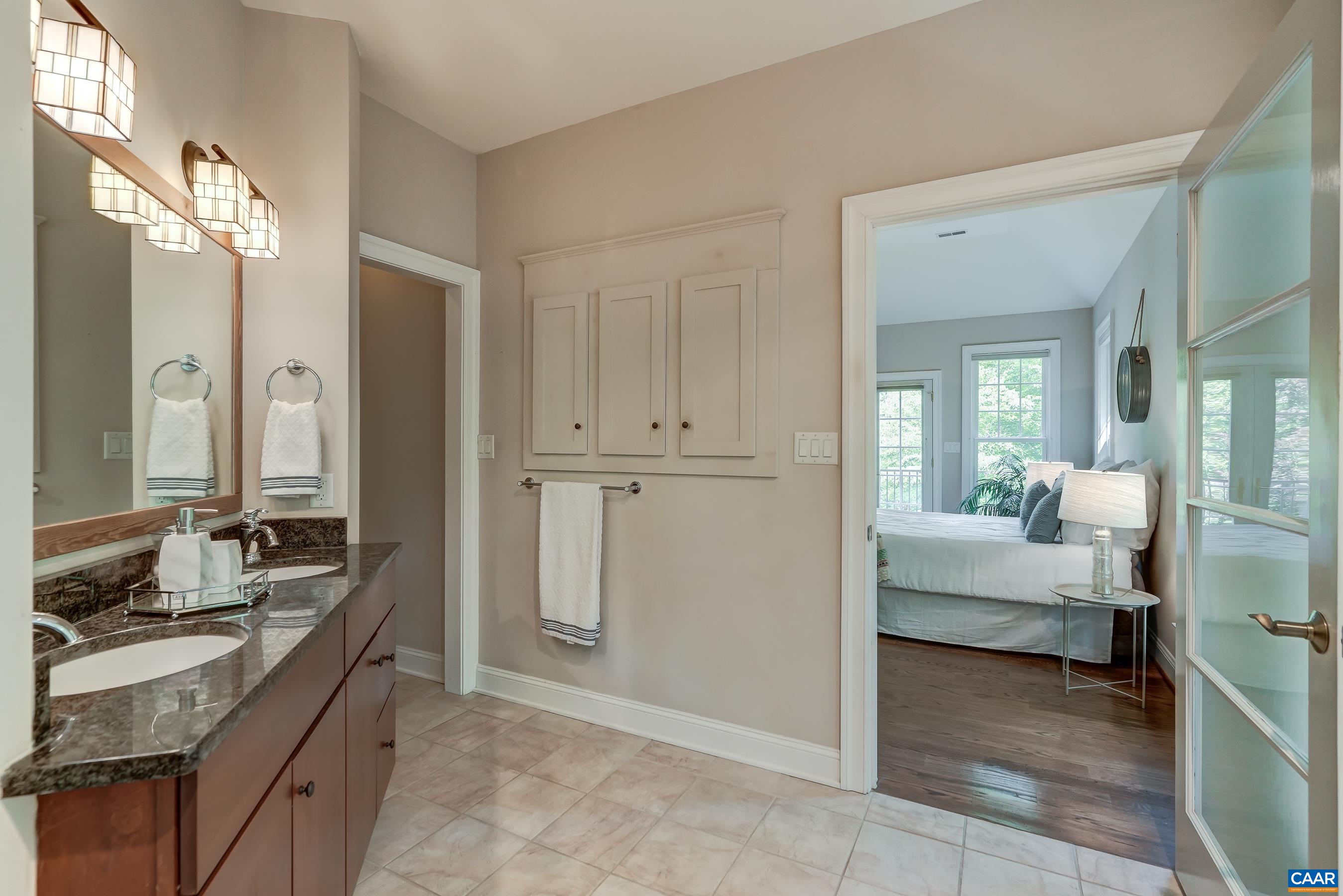 Ensuite bathroom with double sink vanity, soaking tub and walk-in shower.
