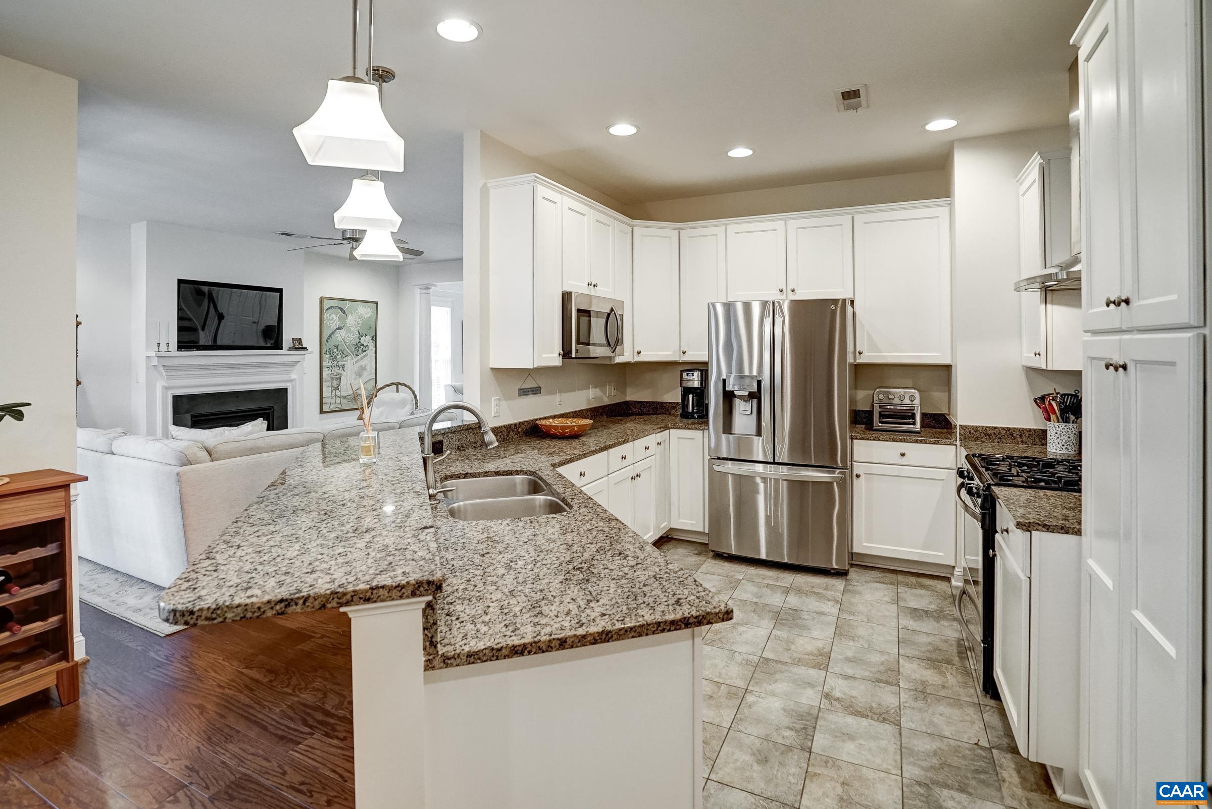 Modern kitchen features crisp white cabinets, stainless appliances and granite countertops. Modern kitchen features crisp white cabinets, stainless appliances and granite countertops.