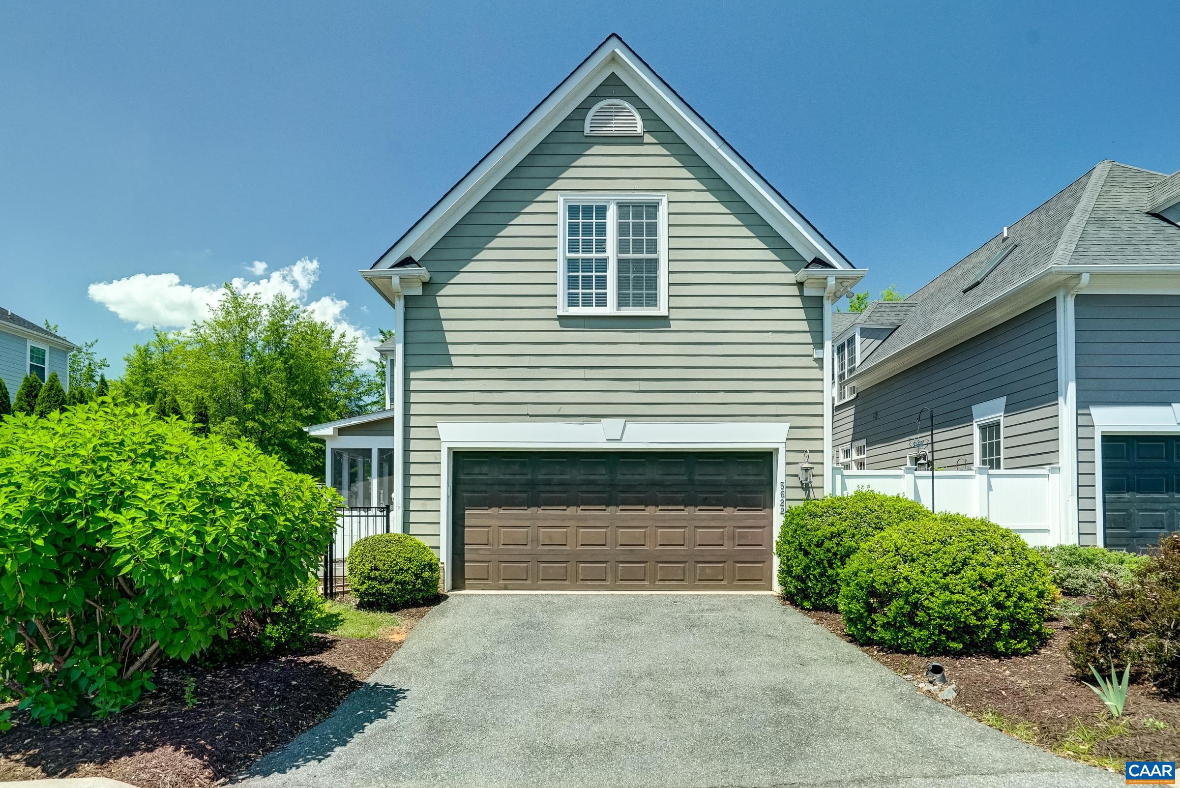 Two car garage and driveway lined with mature plantings. Two car garage and driveway lined with mature plantings.