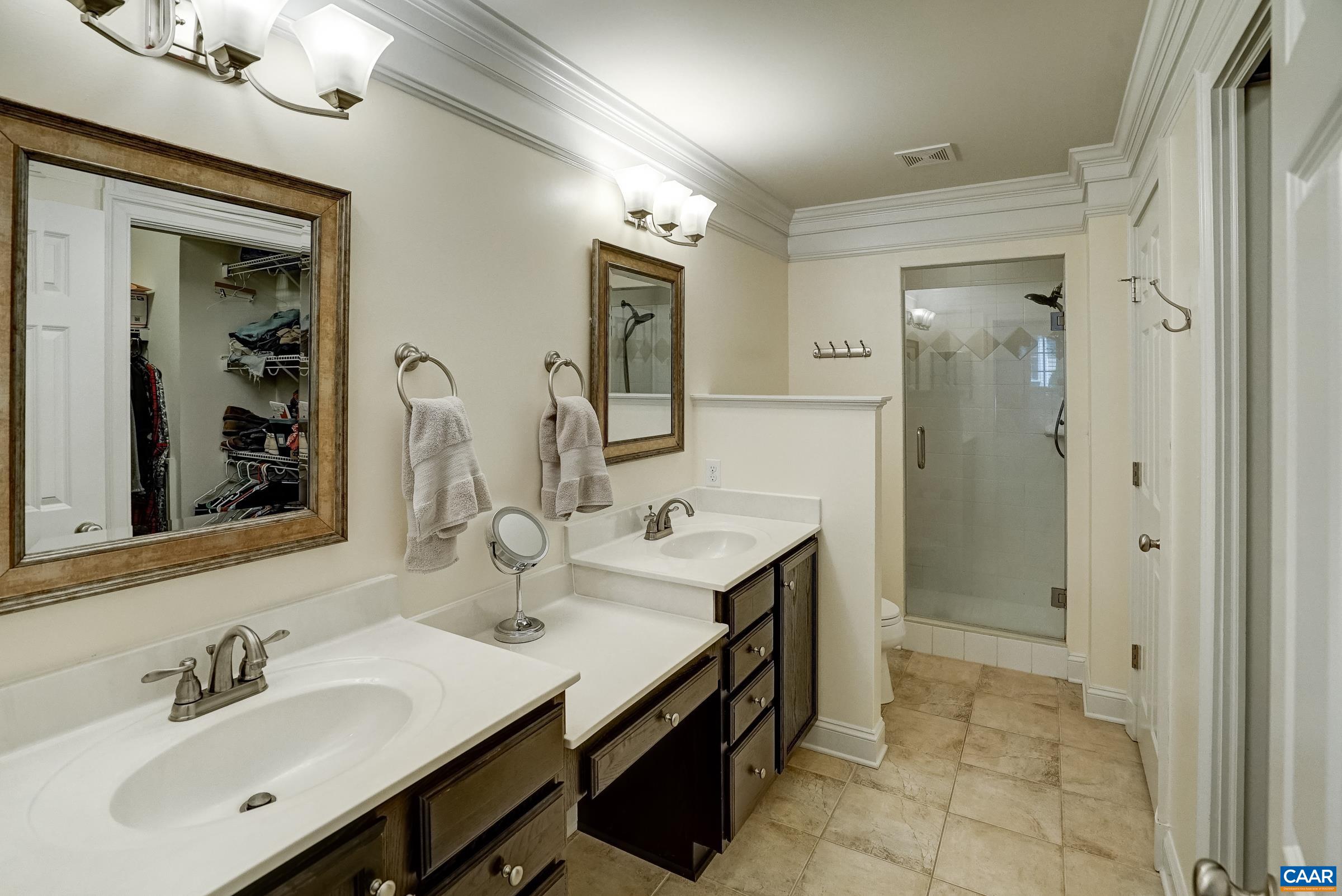 Primary bathroom with two sinks and prep area. Primary bathroom with two sinks and prep area.