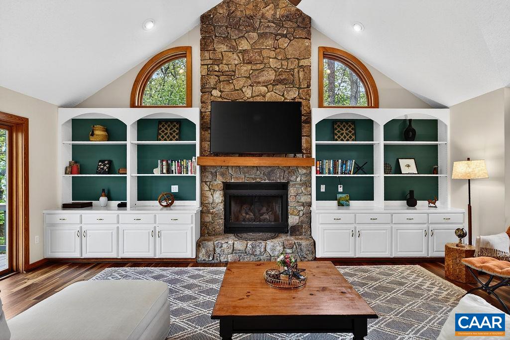 A stunning floor-to-ceiling stone gas-log fireplace serves as the focal point of the great room. A stunning floor-to-ceiling stone gas-log fireplace serves as the focal point of the great room.