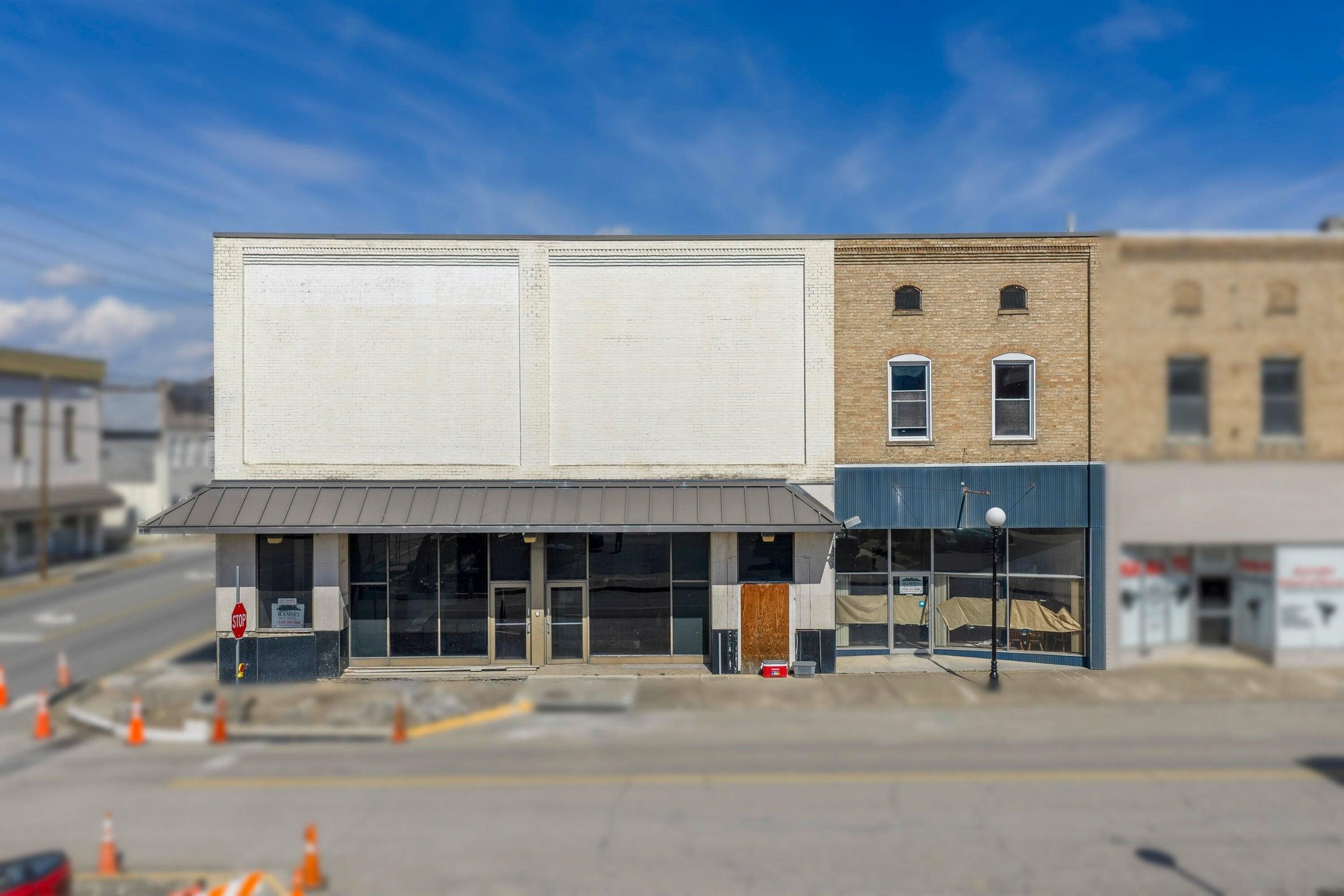 Commercial property includes the white building -- and the tan brick building with the green awning.
