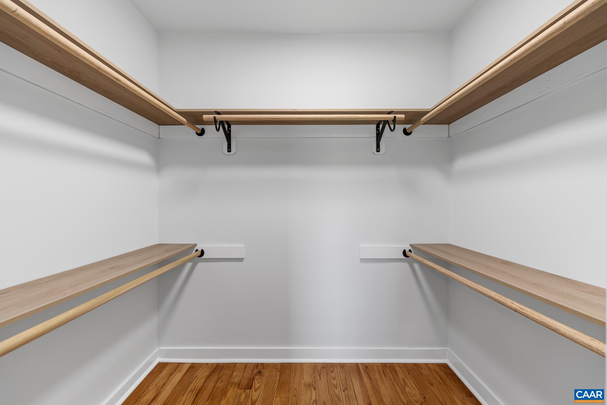 Primary walk in closet with plenty of storage space Primary walk in closet with plenty of storage space