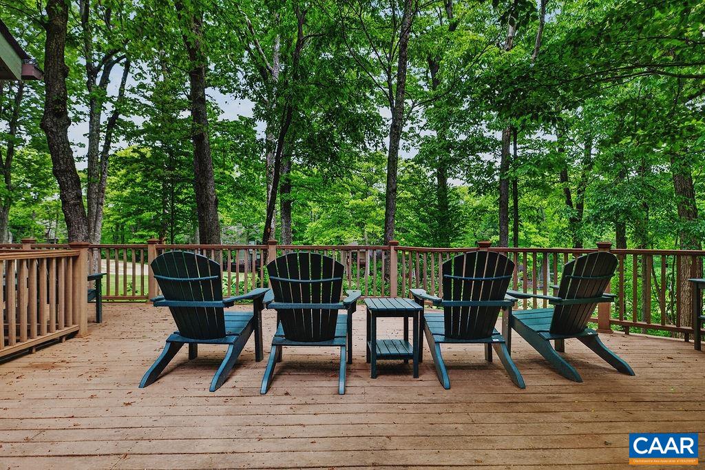 The expansive rear deck offers multiple areas for entertaining, dining, and relaxing while enjoying the beautiful surrounding views.