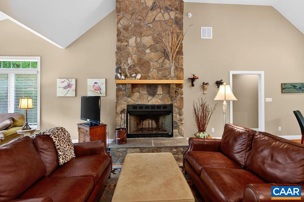 The great room features an elegant sitting area centered around a stunning floor-to-ceiling stone wood-burning fireplace. The great room features an elegant sitting area centered around a stunning floor-to-ceiling stone wood-burning fireplace.