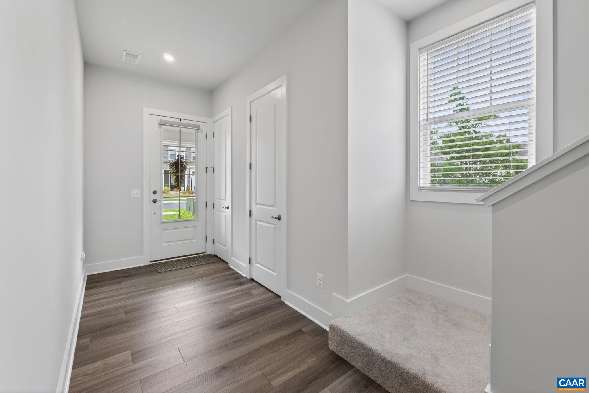 Front foyer upon entering with coat closet and half bath. Front foyer upon entering with coat closet and half bath.