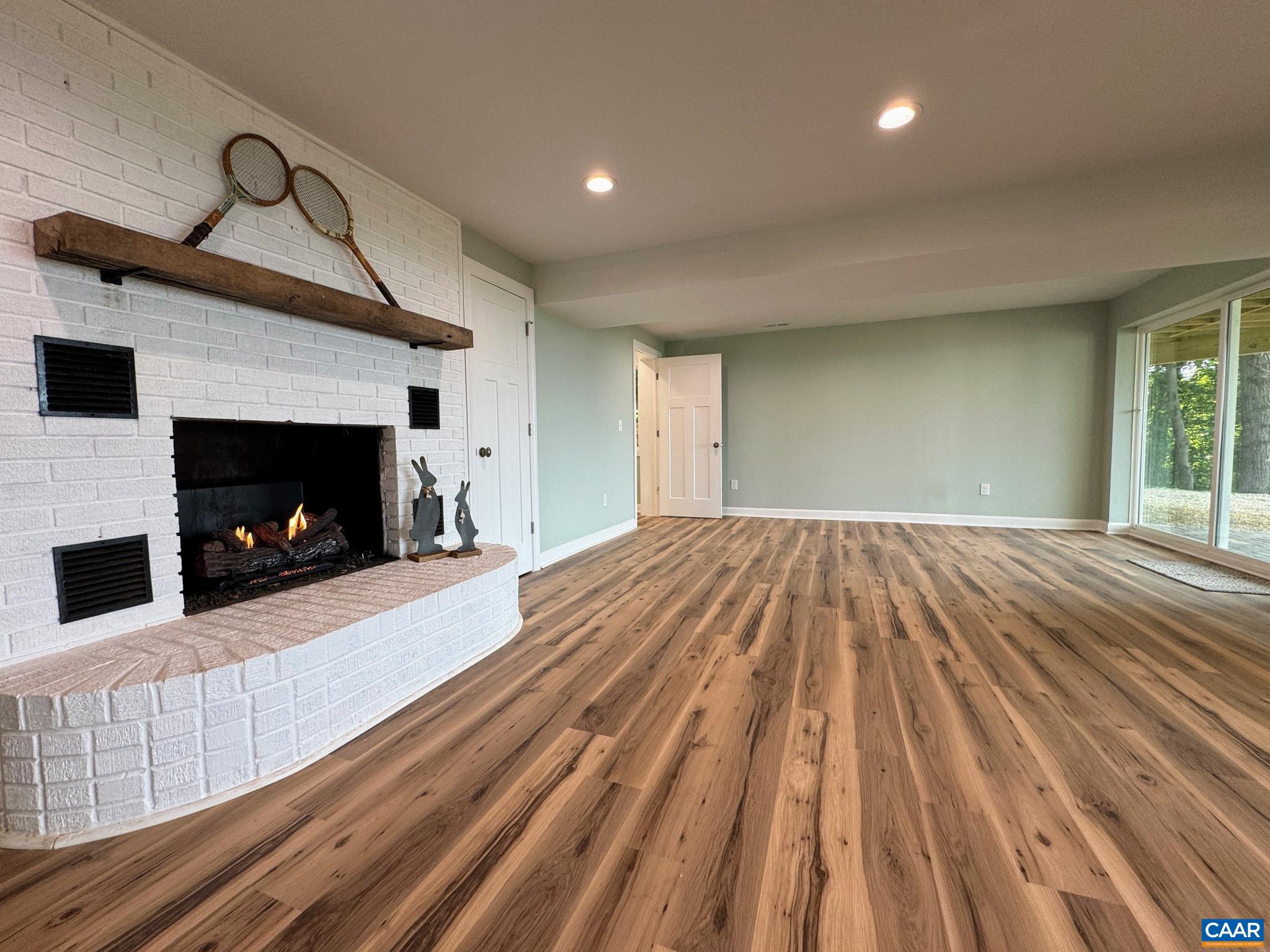 ...with Brick Gas Fireplace, Luxury Vinyl Plank Flooring. ...with Brick Gas Fireplace, Luxury Vinyl Plank Flooring.