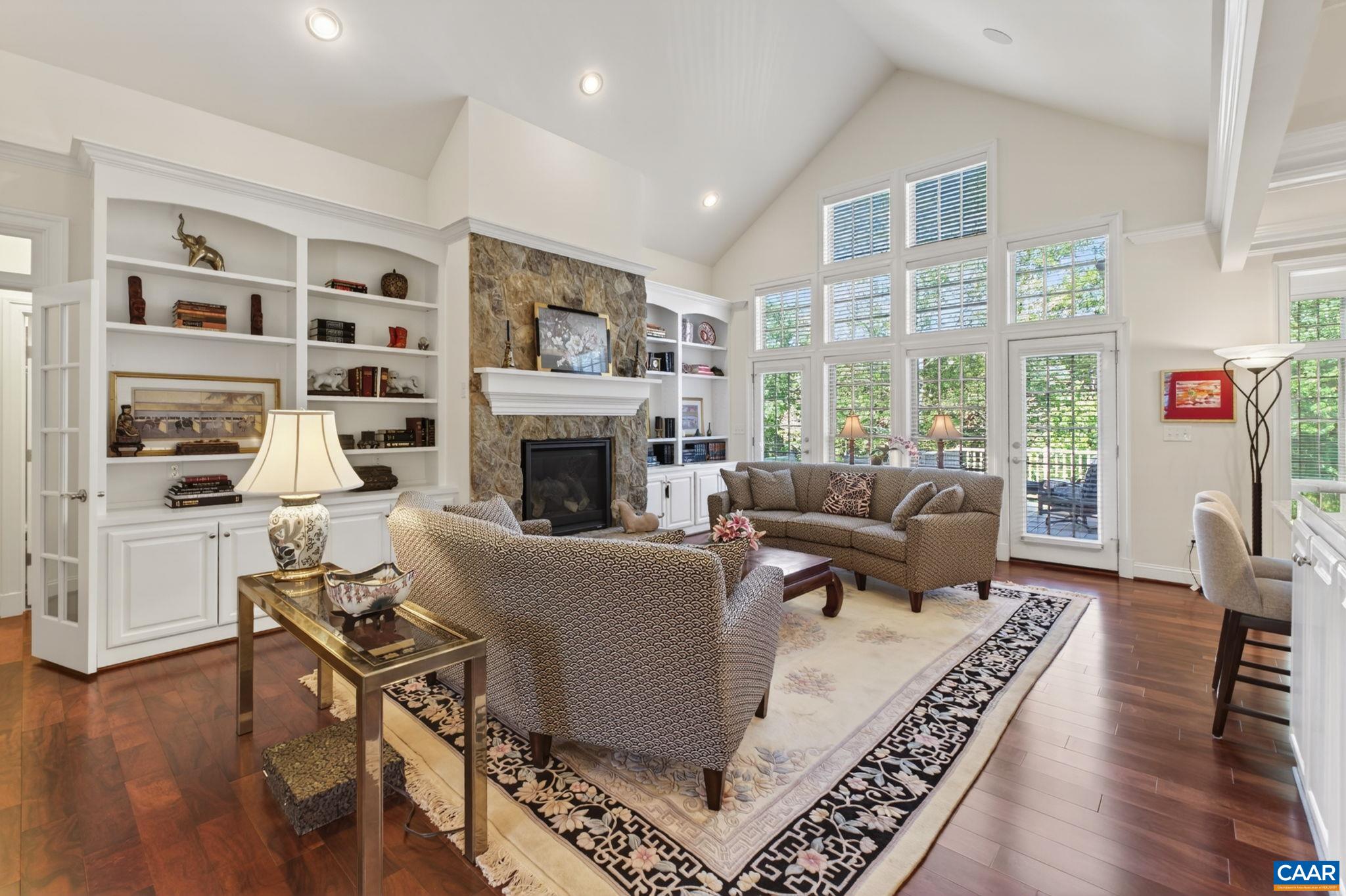 featuring stone FP with custom built-in cabinetry, and gleaming wood floors in a rich honey shade. featuring stone FP with custom built-in cabinetry, and gleaming wood floors in a rich honey shade.