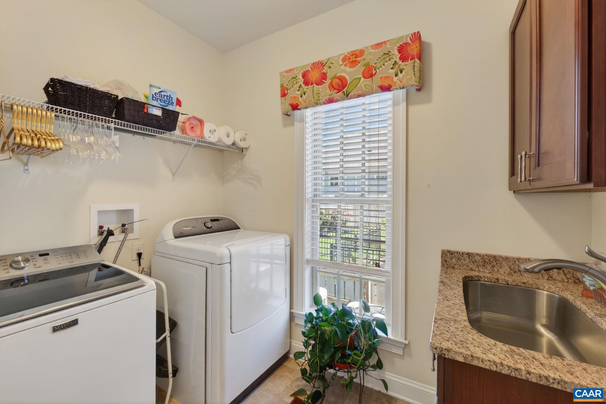 with full-sized sink and upgraded granite, storage cabinets, and an attached ironing board. with full-sized sink and upgraded granite, storage cabinets, and an attached ironing board.