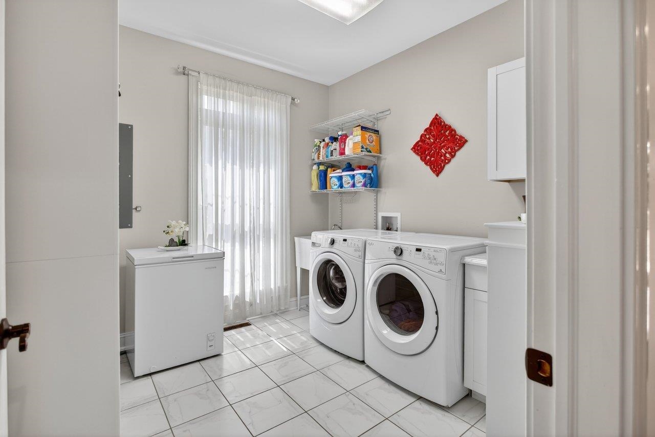 Washer and Dryer convey . There is a utility sink, tile flooring and lots of storage Washer and Dryer convey . There is a utility sink, tile flooring and lots of storage