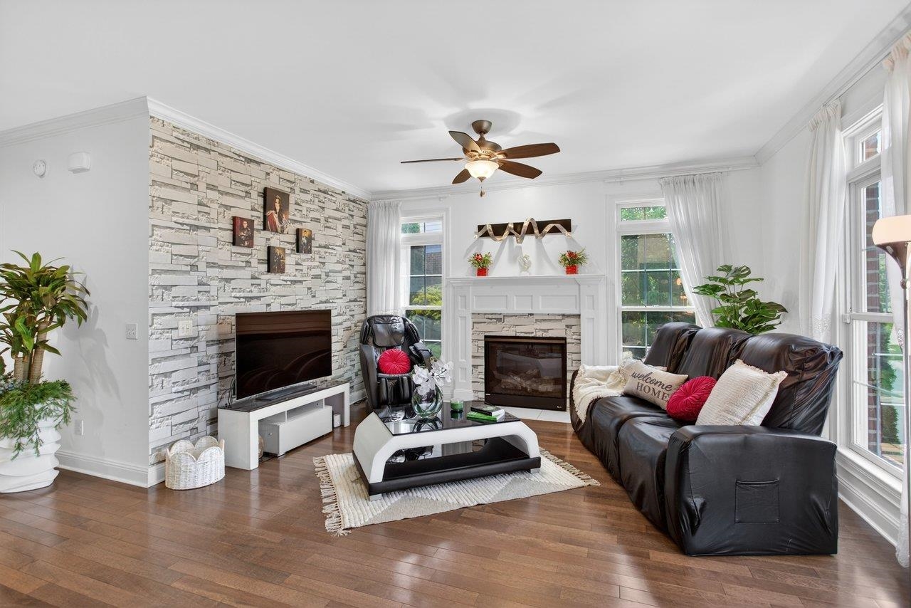 Step inside to a welcoming living room with fireplace and lots of natural light. The lovely hardwood foors and high ceilings extend throughout the house Step inside to a welcoming living room with fireplace and lots of natural light. The lovely hardwood foors and high ceilings extend throughout the house
