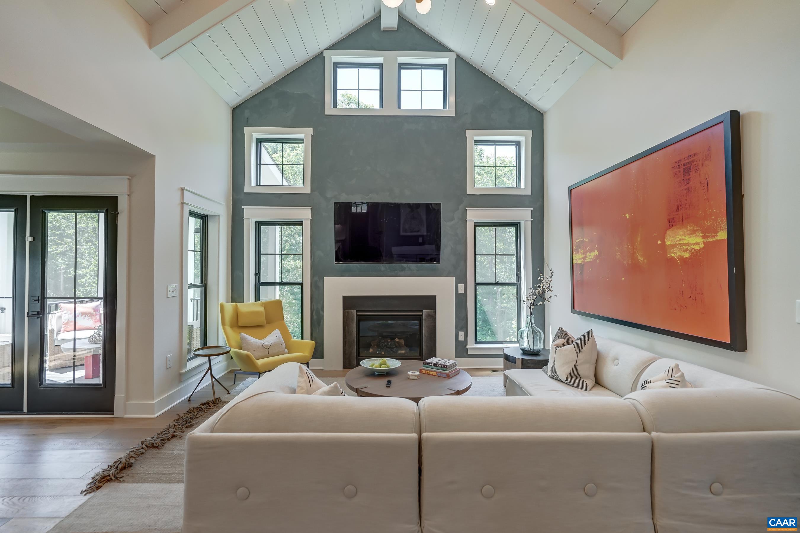 Vaulted great room features a gas fireplace with custom finished accent wall, and ship lap ceiling. Vaulted great room features a gas fireplace with custom finished accent wall, and ship lap ceiling.
