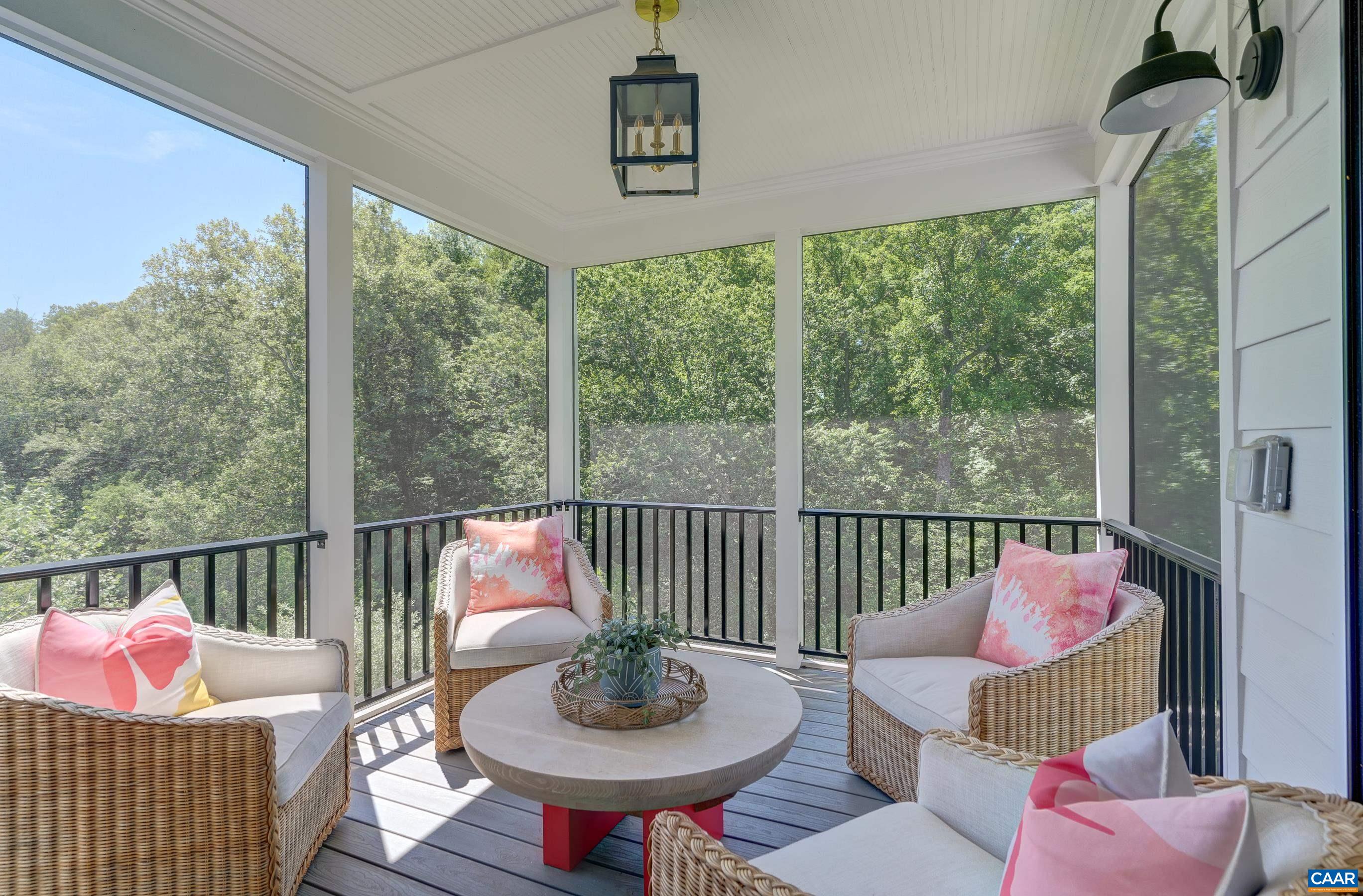 Screened in porch overlooks wooded common area behind home. Screened in porch overlooks wooded common area behind home.