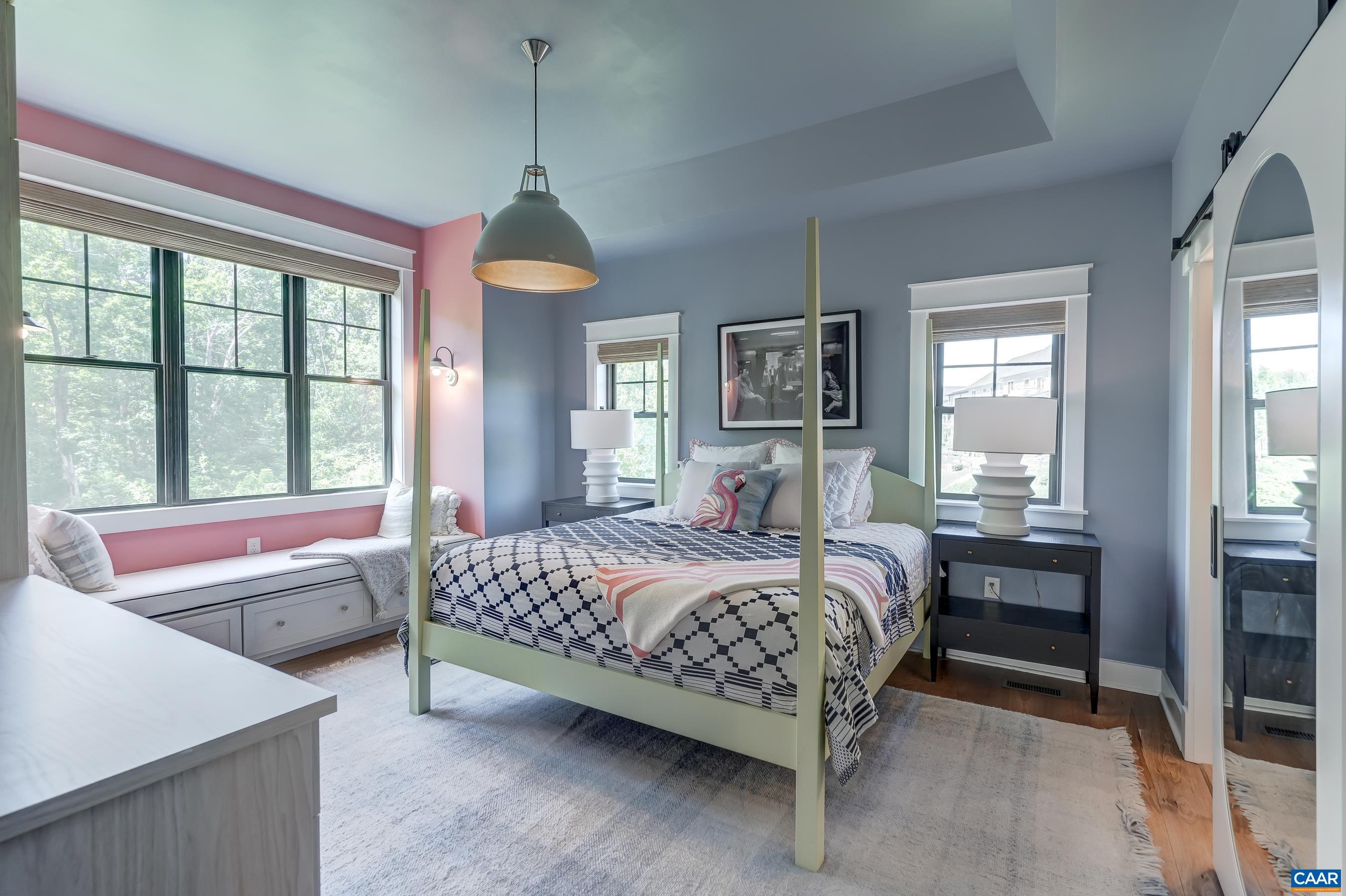 Main level primary suite features stunning light fixture, and built-in window seat with storage. Main level primary suite features stunning light fixture, and built-in window seat with storage.