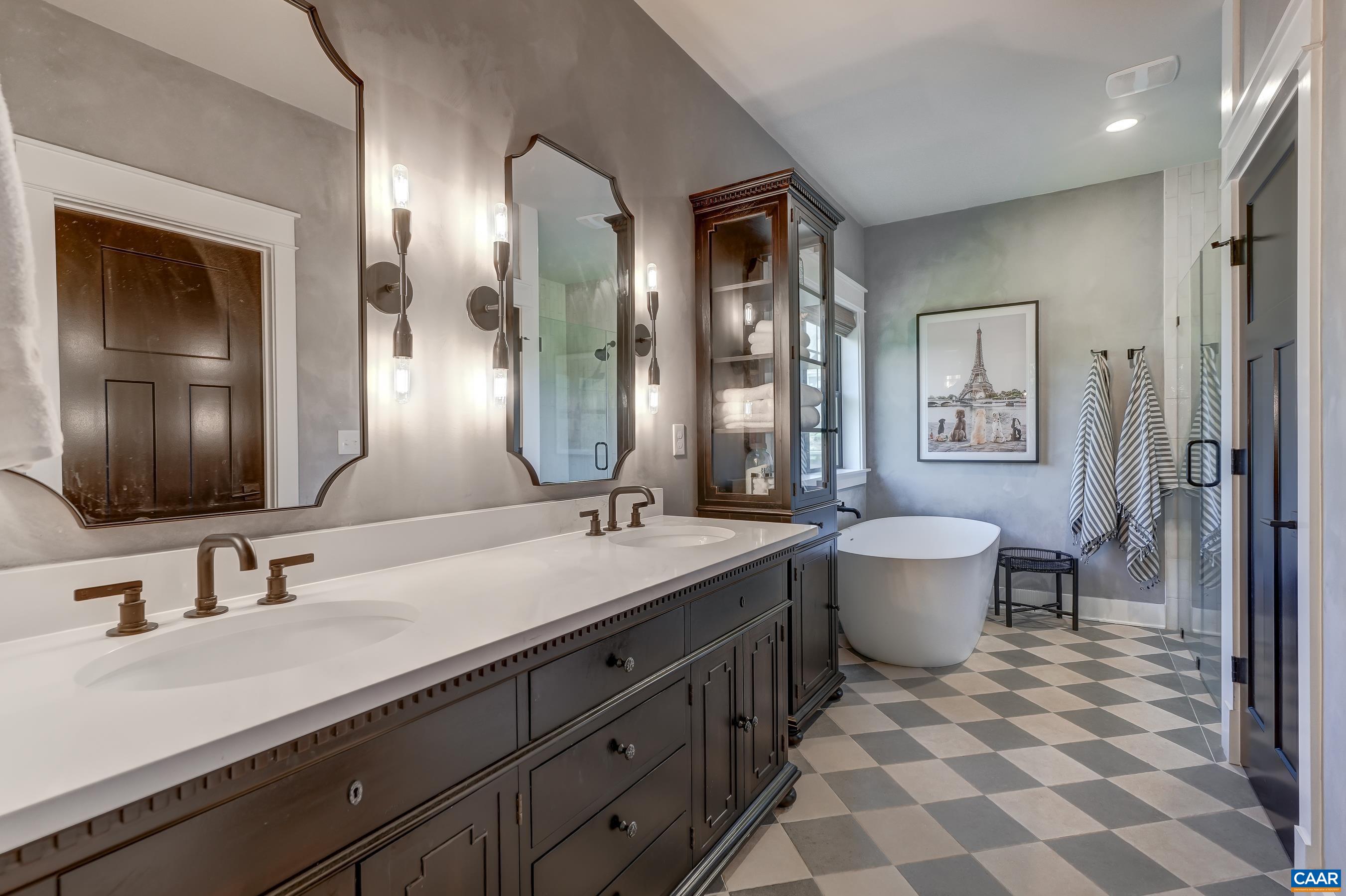 Spa-like ensuite primary bathroom features dual sink quartz vanity. Spa-like ensuite primary bathroom features dual sink quartz vanity.