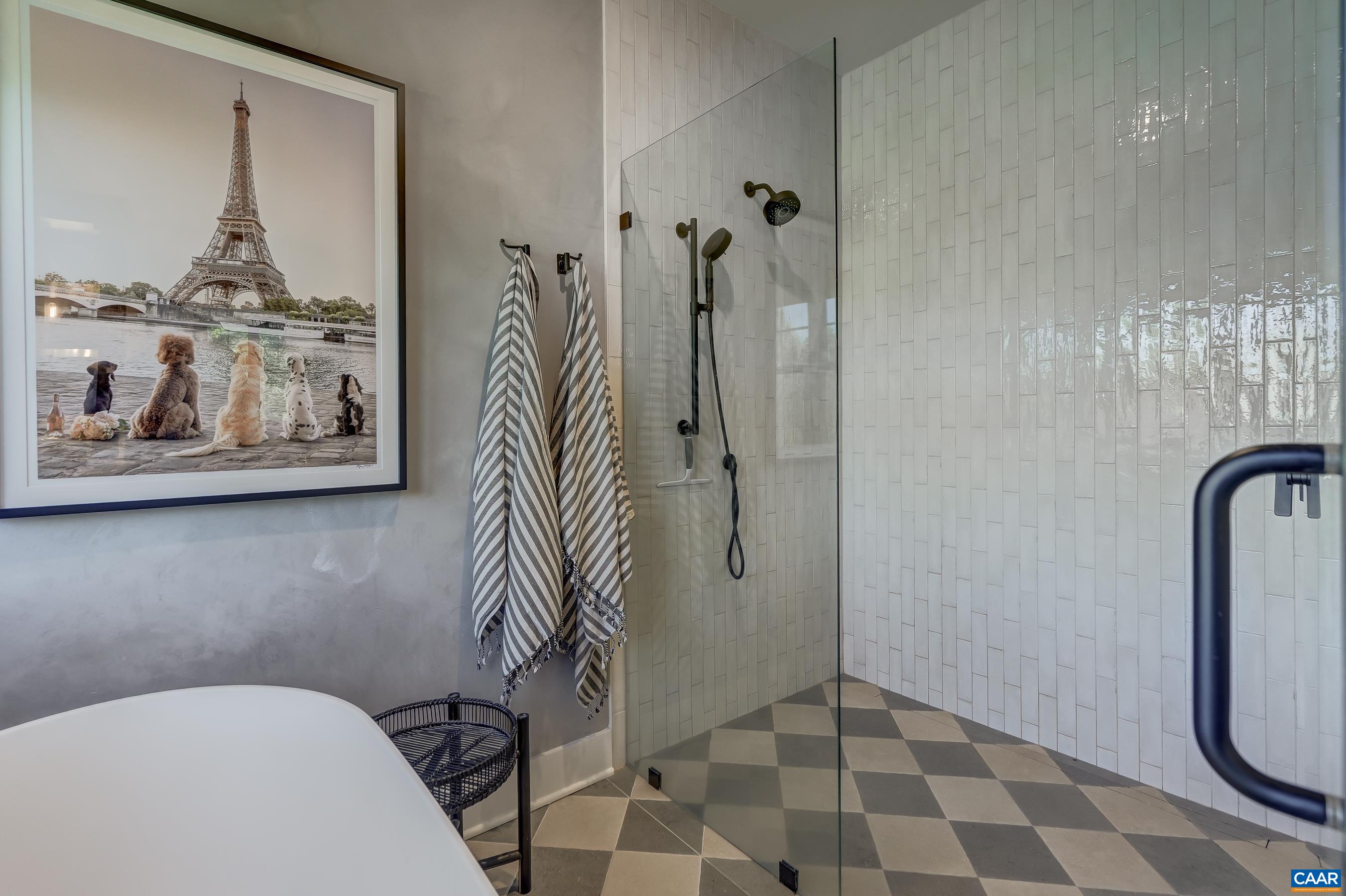 Frameless glass shower features curbless entry. Frameless glass shower features curbless entry.