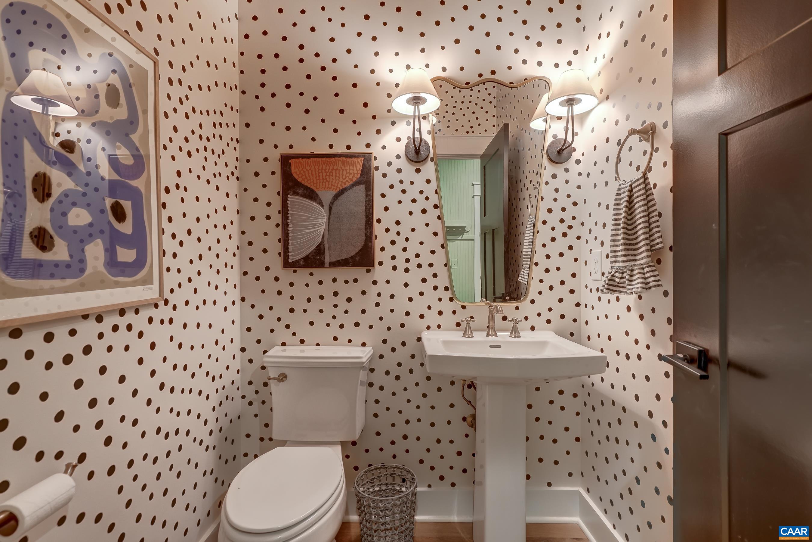 Powder room with custom wall treatment and pedestal sink. Powder room with custom wall treatment and pedestal sink.