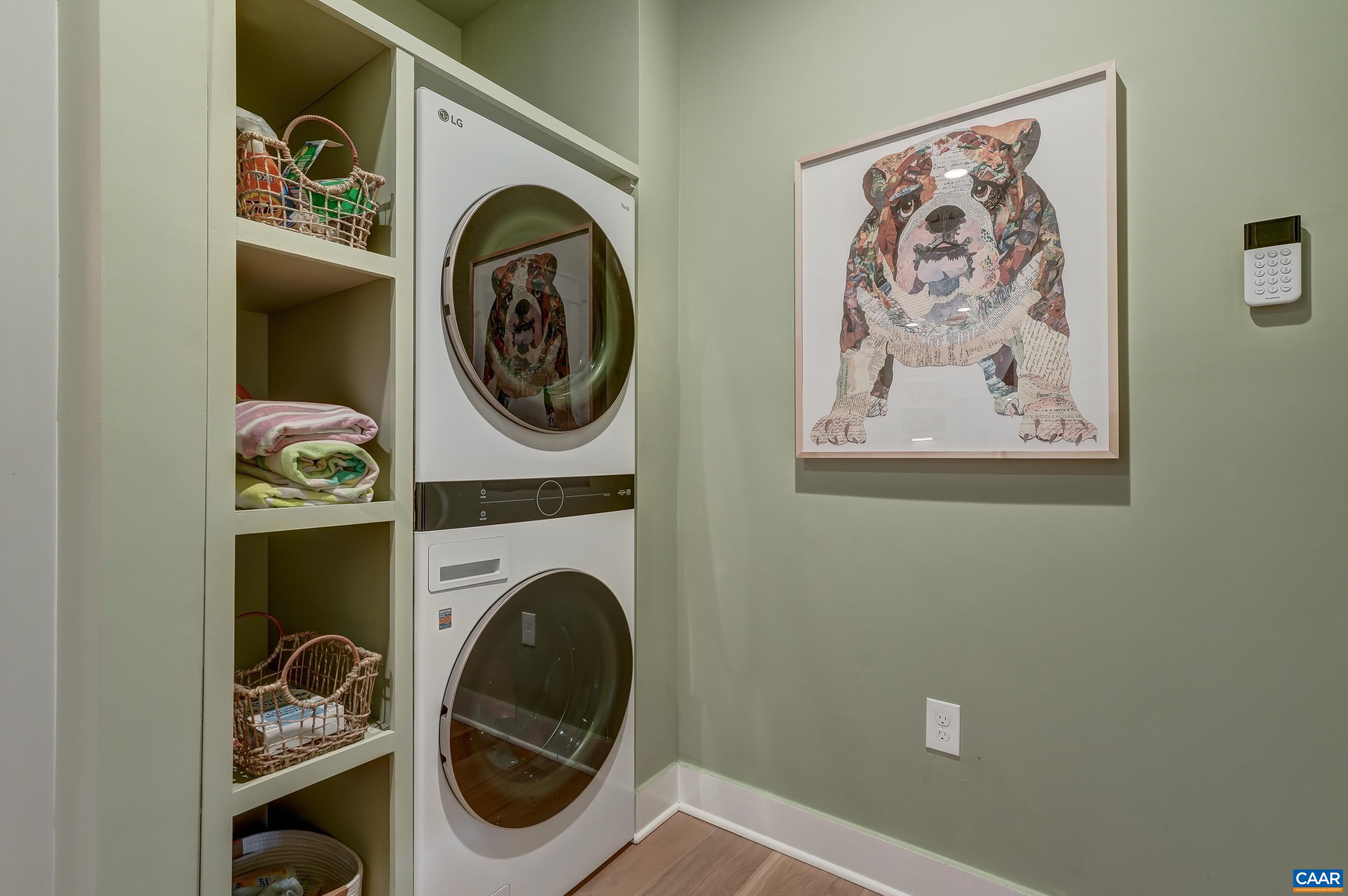 Large mudroom includes stacked LG washer and dryer, storage hooks and cubbies. Large mudroom includes stacked LG washer and dryer, storage hooks and cubbies.