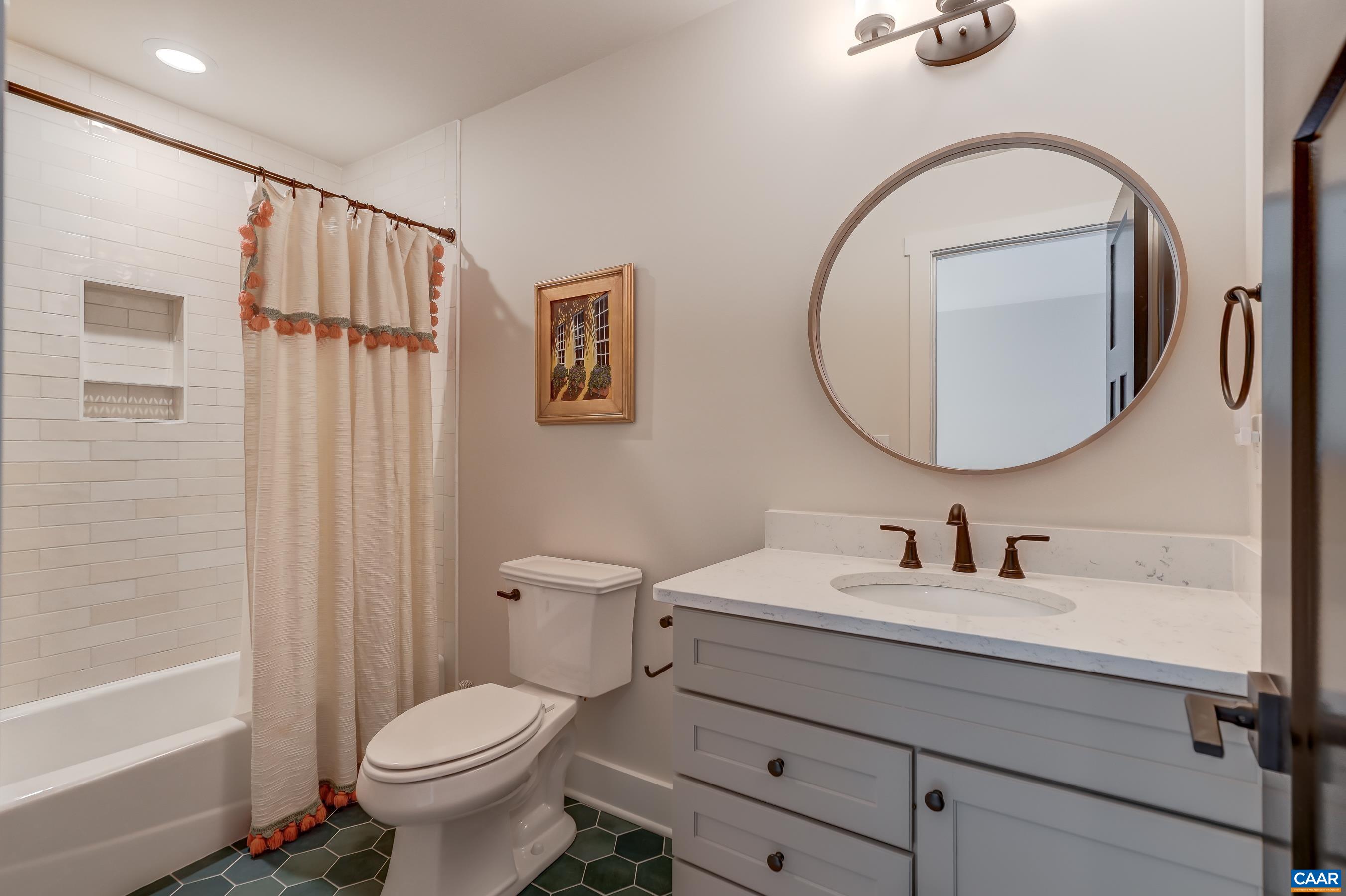 Ensuite guest bathroom features tub/shower combo. Ensuite guest bathroom features tub/shower combo.