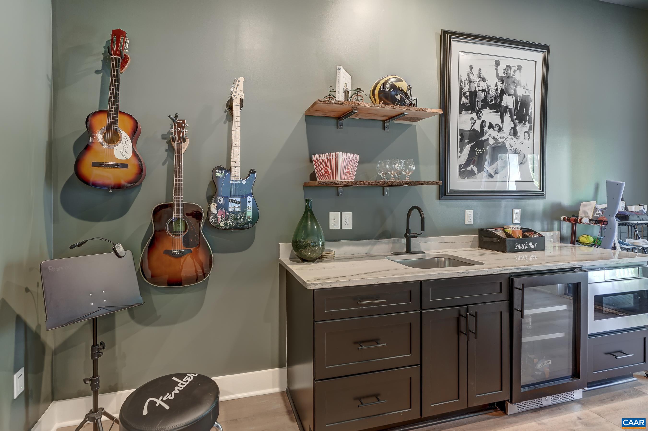 Wet bar in basement with wine cooler. Wet bar in basement with wine cooler.