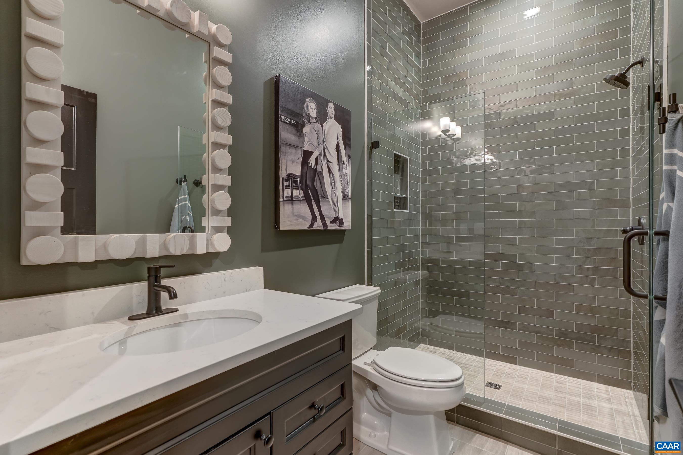 Basement features a full bathroom with frameless glass shower. Basement features a full bathroom with frameless glass shower.