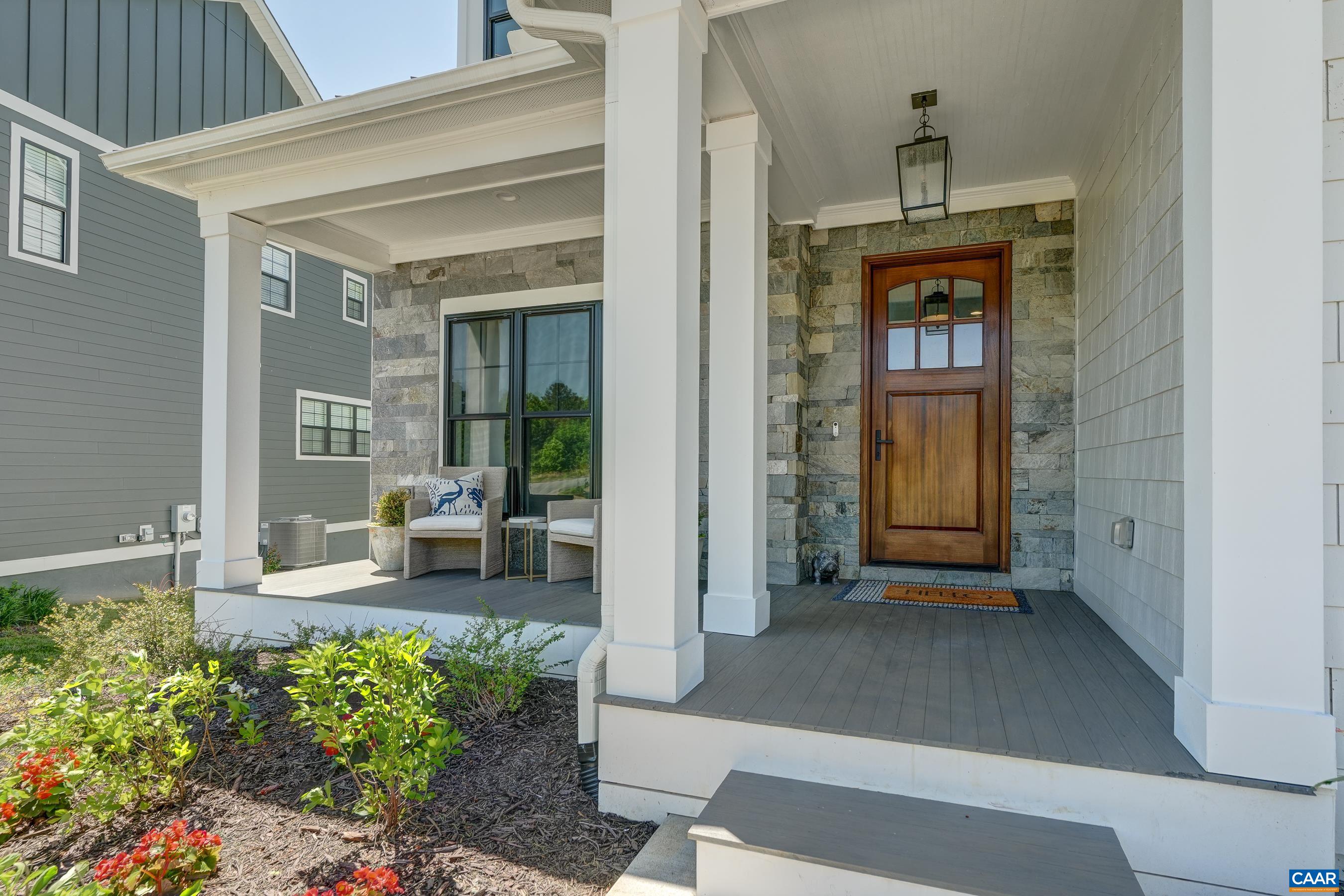 Charming front porch with solid wood door. Charming front porch with solid wood door.