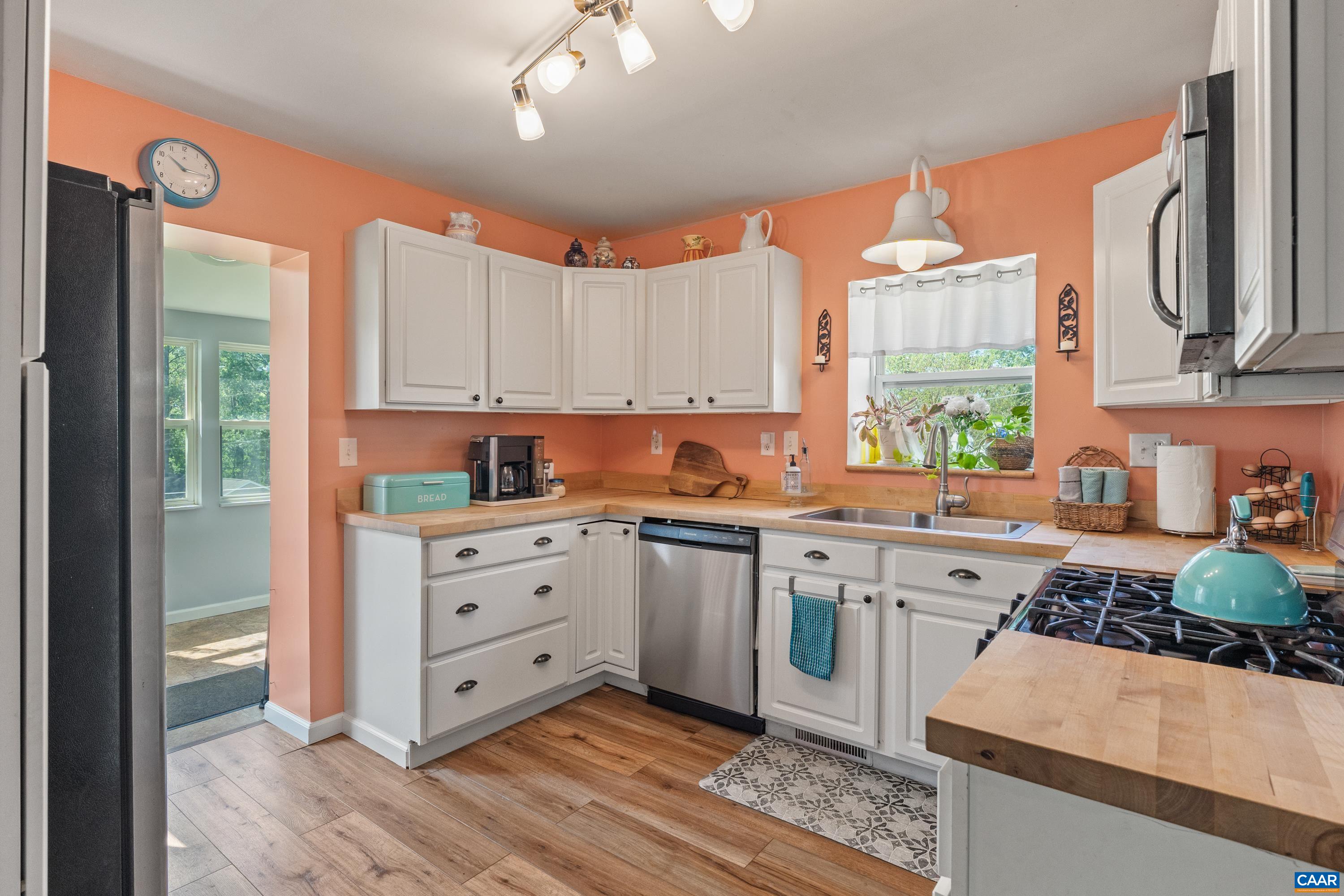Kitchen with wooden cabinetry and generous workspace. Kitchen with wooden cabinetry and generous workspace.