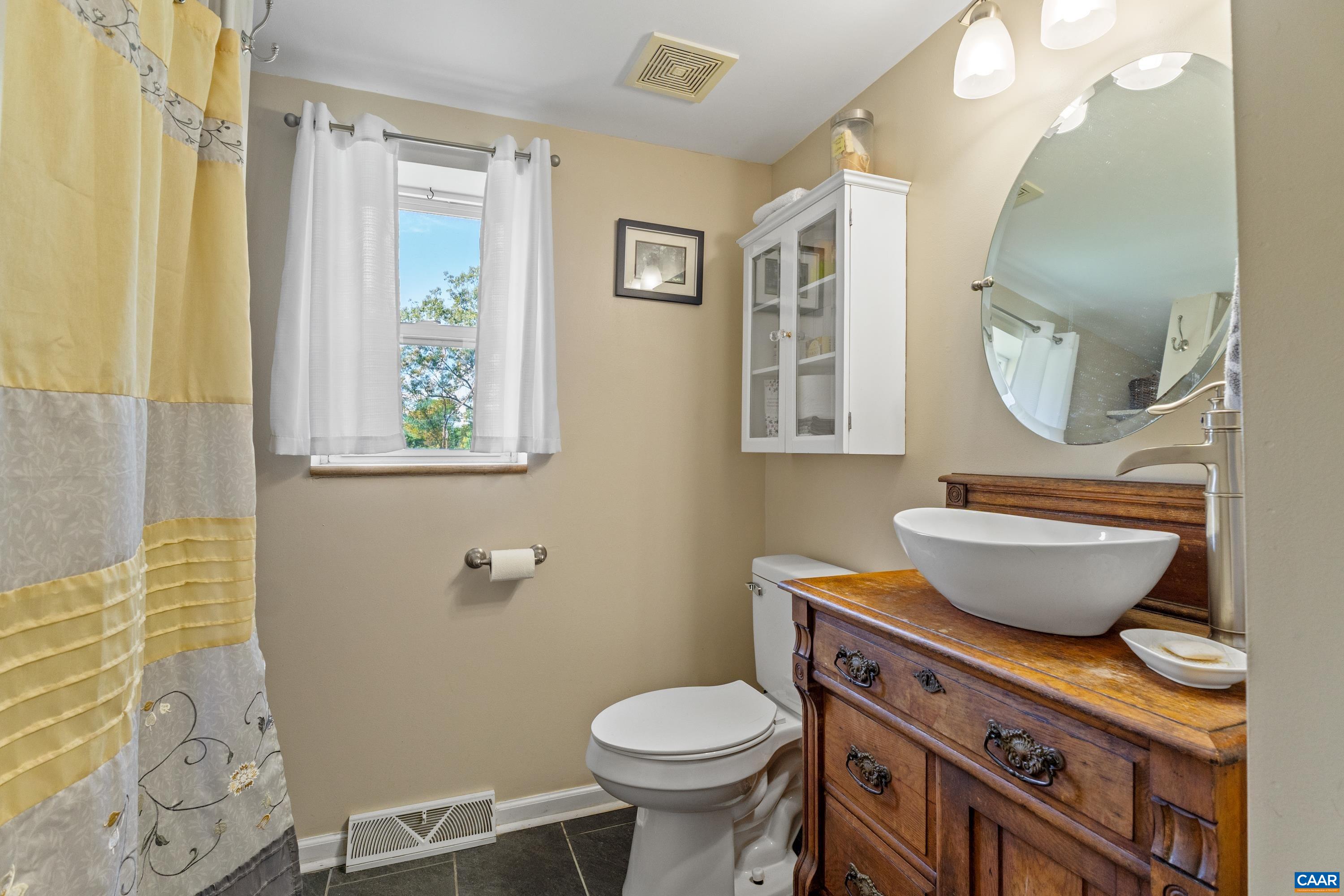 Primary bathroom with vanity, window, and shower. Primary bathroom with vanity, window, and shower.