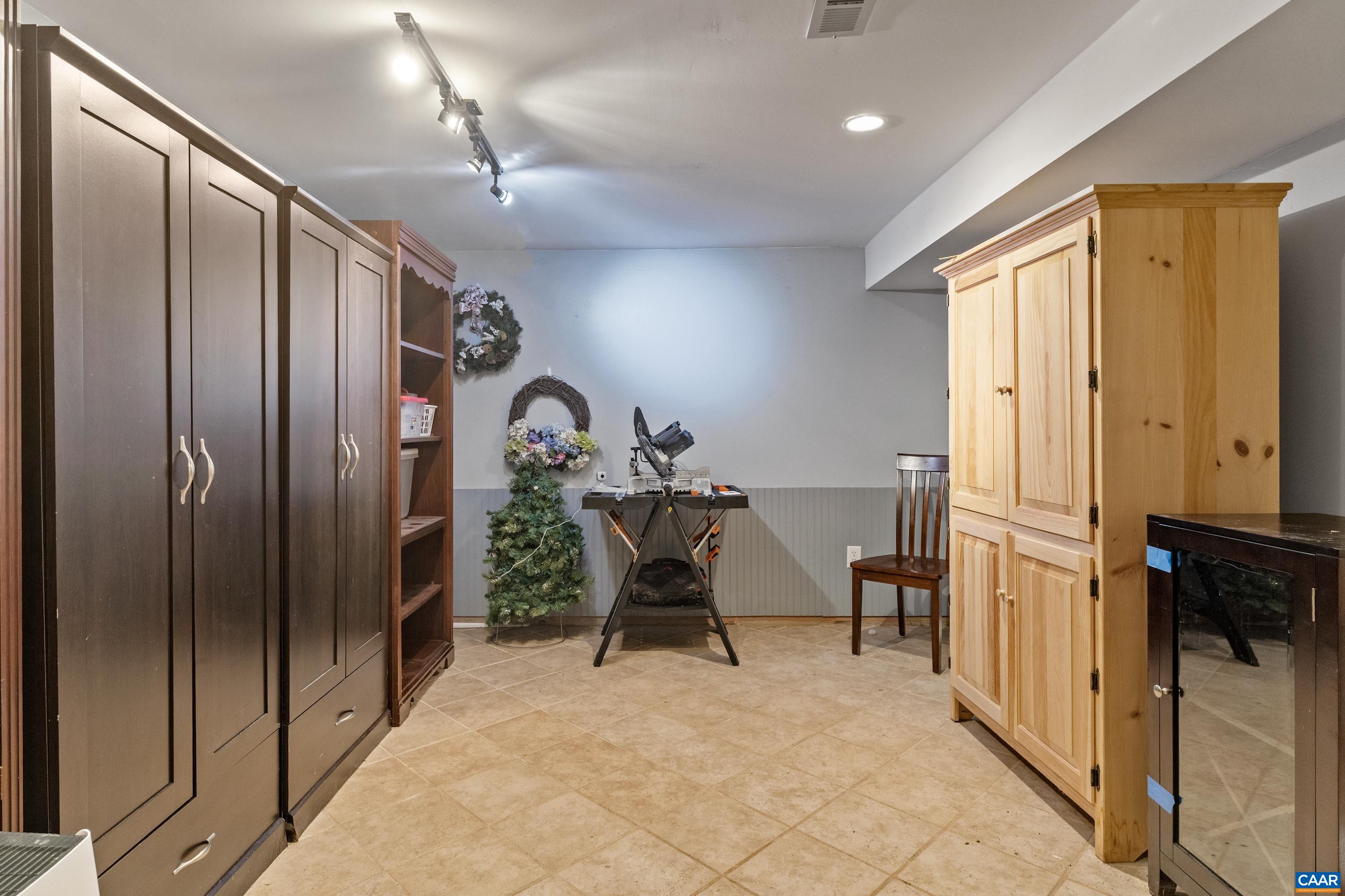 Lower-level utility/storage area with ample room for household organization. Lower-level utility/storage area with ample room for household organization.