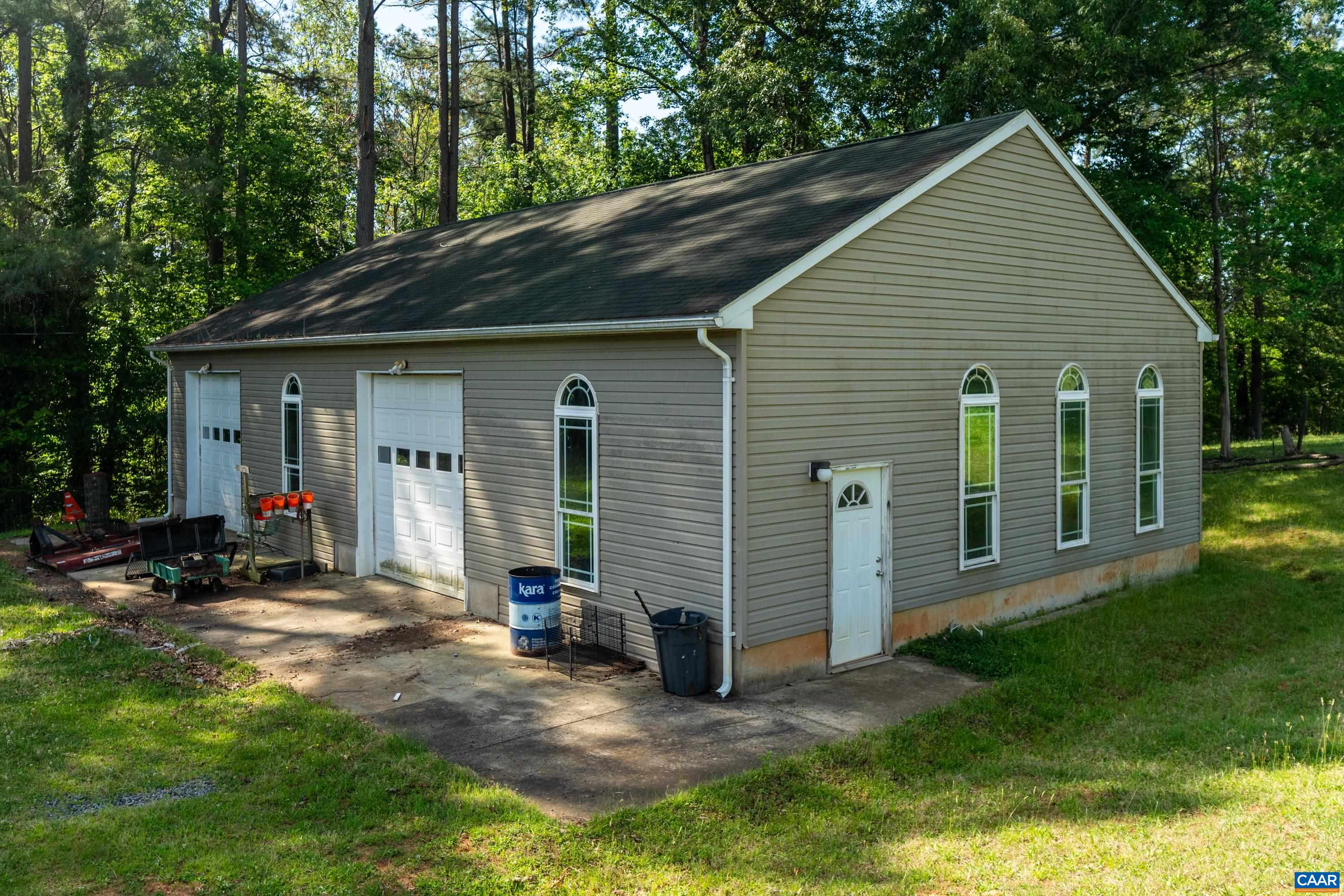 Large detached workshop/outbuilding with overhead door and easy access for equipment or projects. Large detached workshop/outbuilding with overhead door and easy access for equipment or projects.