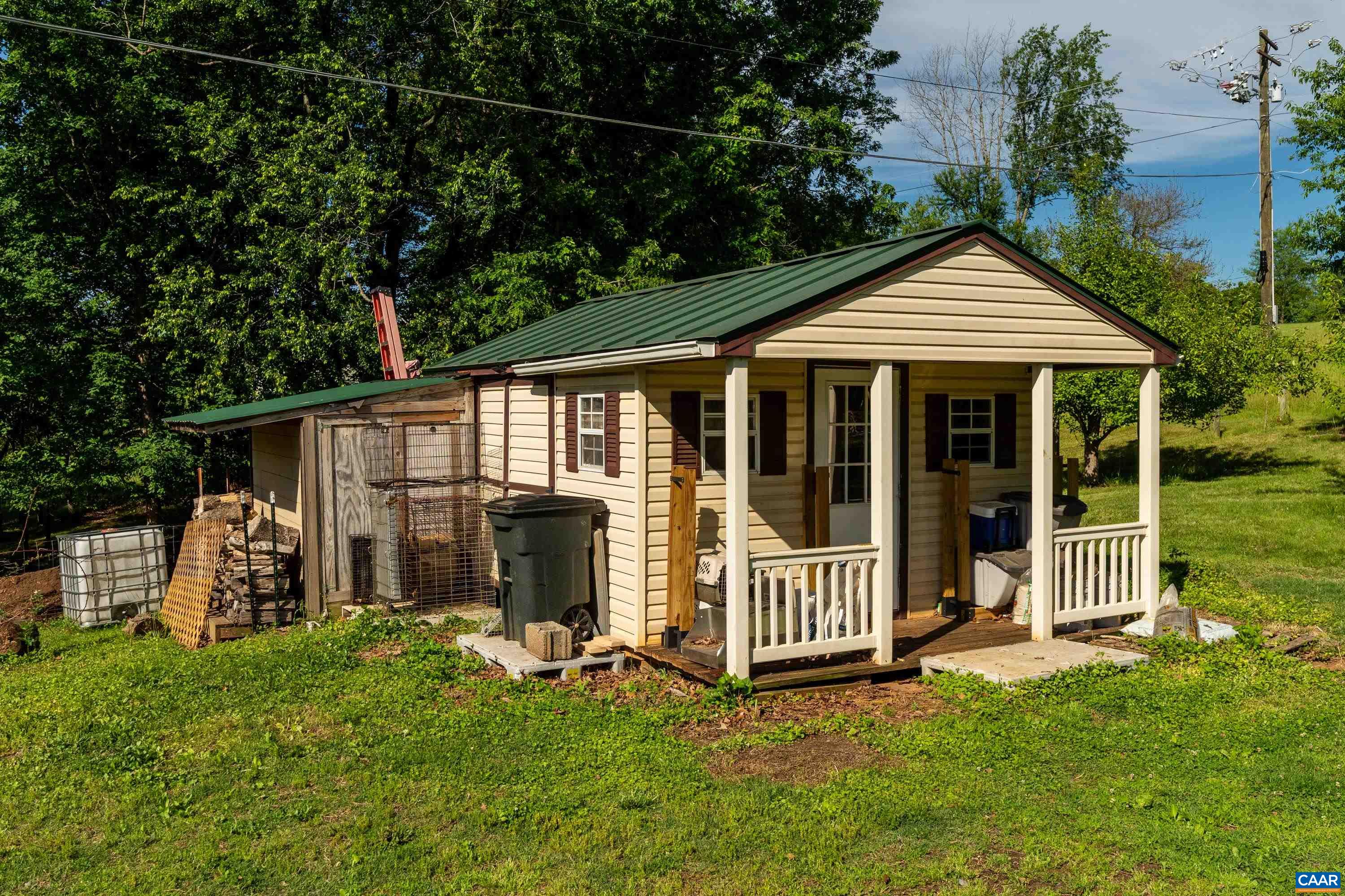 Small outbuilding with covered porch, offering flexible use for storage, hobbies, or homestead needs. Small outbuilding with covered porch, offering flexible use for storage, hobbies, or homestead needs.