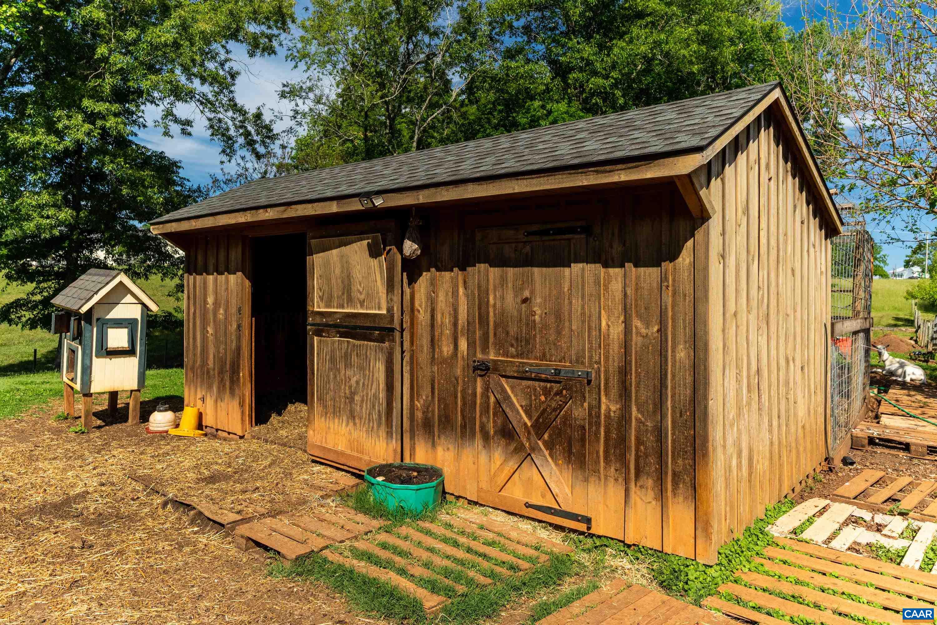 Wood-sided storage shed for tools, equipment, feed, or animal husbandry. Wood-sided storage shed for tools, equipment, feed, or animal husbandry.