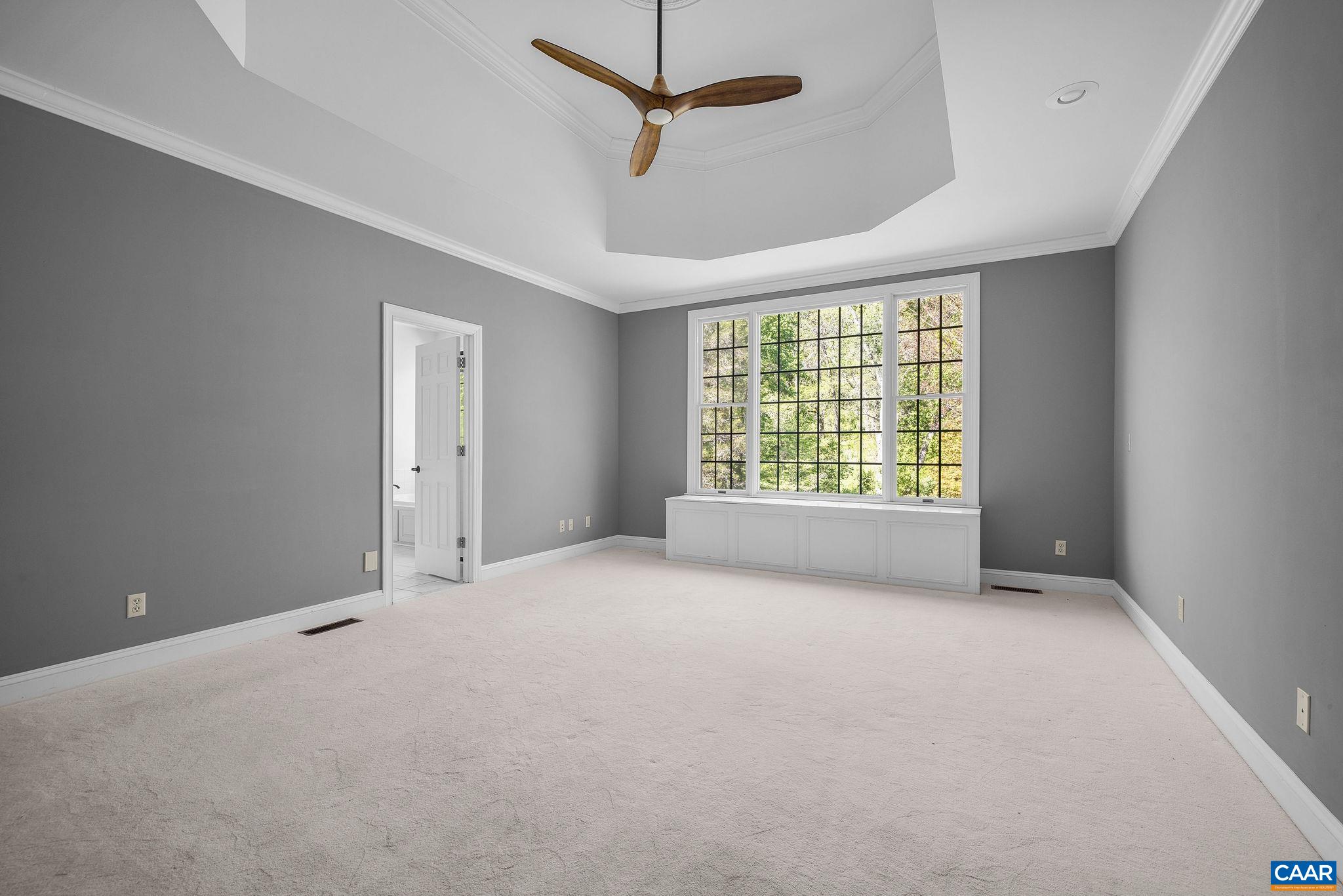 Primary bedroom overlooking the lush rear yard. Primary bedroom overlooking the lush rear yard.
