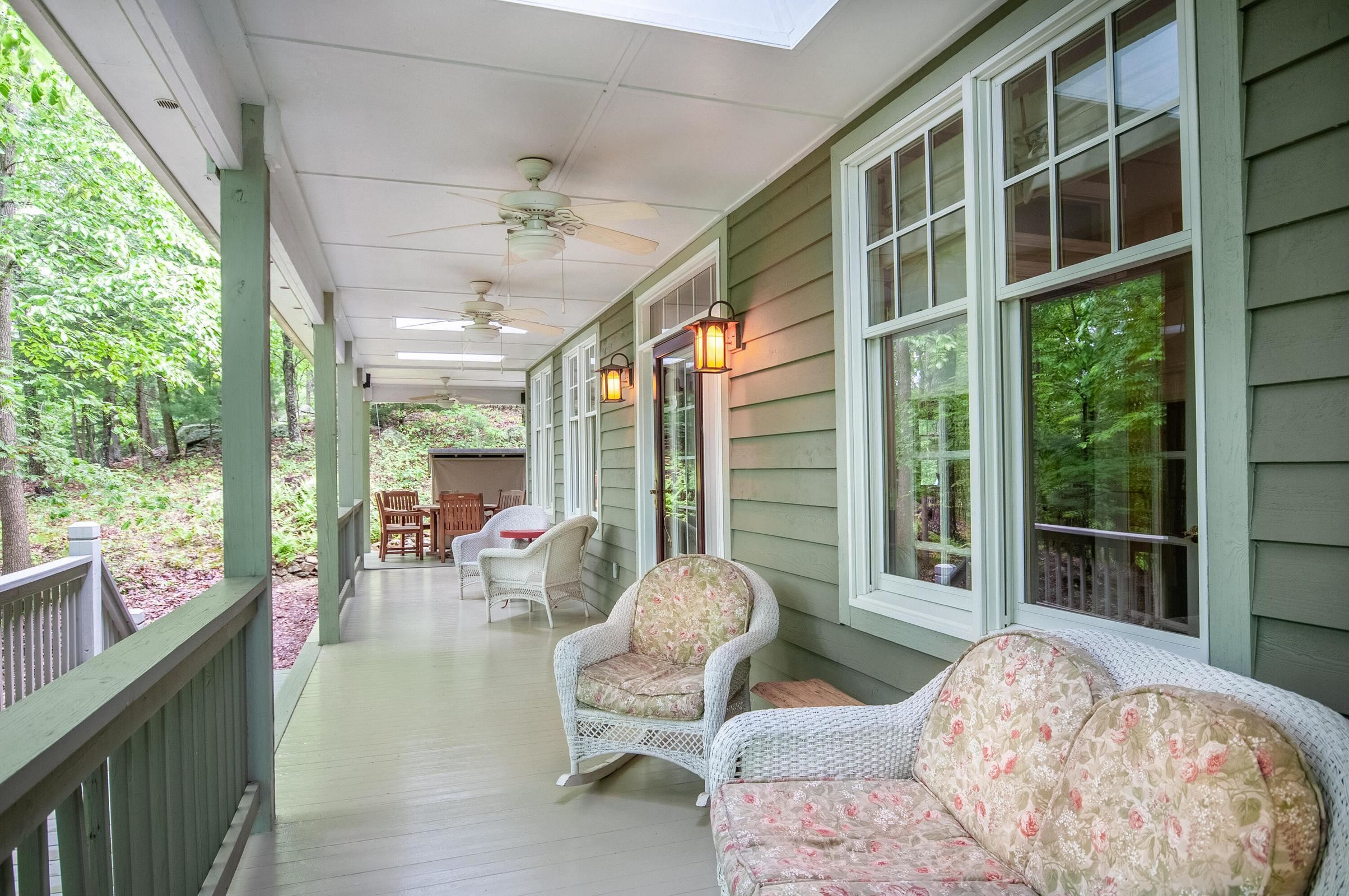 The comfortable porch wraps around much of the home. The comfortable porch wraps around much of the home.