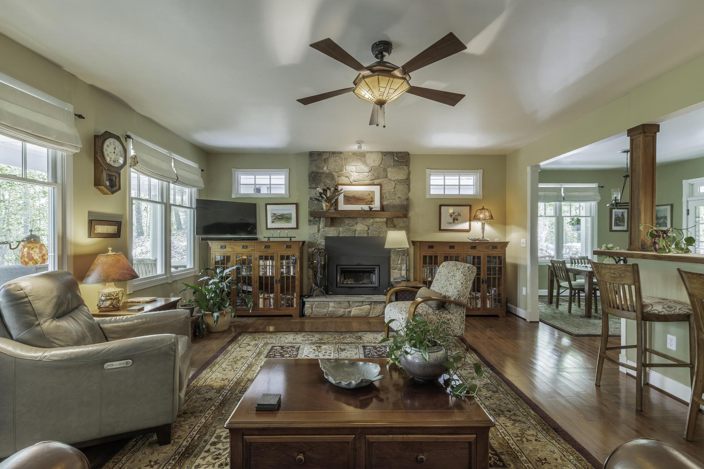 Beautiful wood floors. Elegant Living Room with large windows looking out to nature. Beautiful wood floors. Elegant Living Room with large windows looking out to nature.