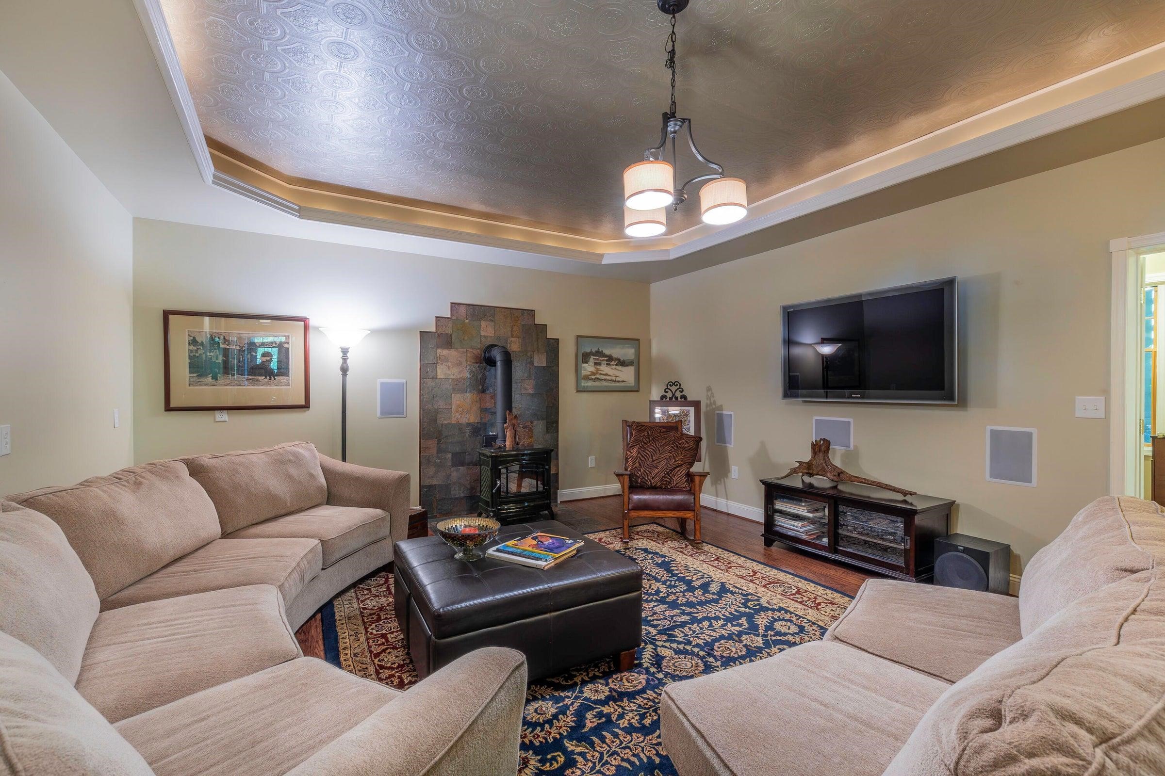 Elegant wood stove with stone surround. Wood floors. Elegant wood stove with stone surround. Wood floors.