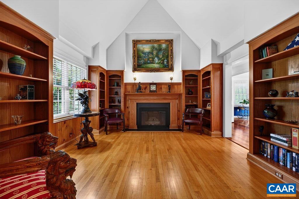 A beautiful study featuring stunning built-ins and a gas log fireplace welcomes you as you enter this magnificent home