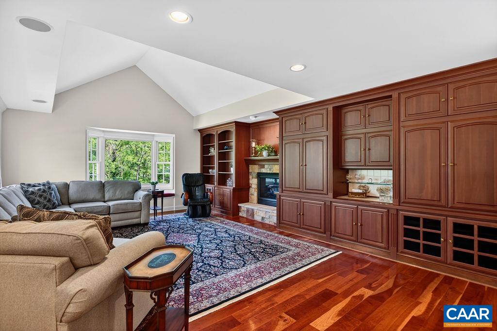 A stunning great room featuring custom cherry wood built-ins and a gas log fireplace