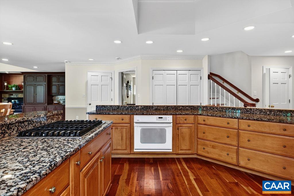 The beautiful kitchen opens seamlessly to the great room, breakfast nook, and formal dining room