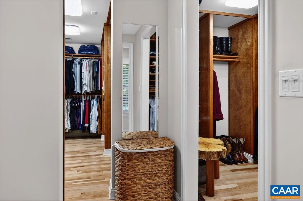 The primary suite offers two large walk-in closets with custom built-in shelving. They are absolutely stunning.