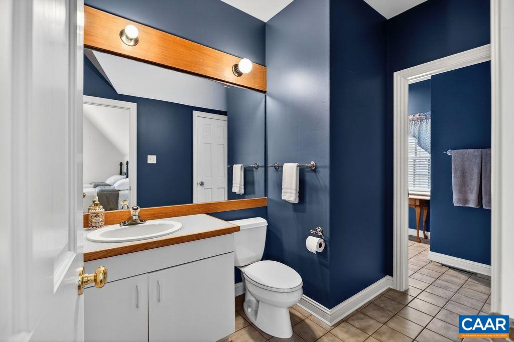 The two guest bedrooms are connected by a spacious bath configuration where each bedroom has its own private half bath while sharing a central shower — a wonderful and highly functional layout