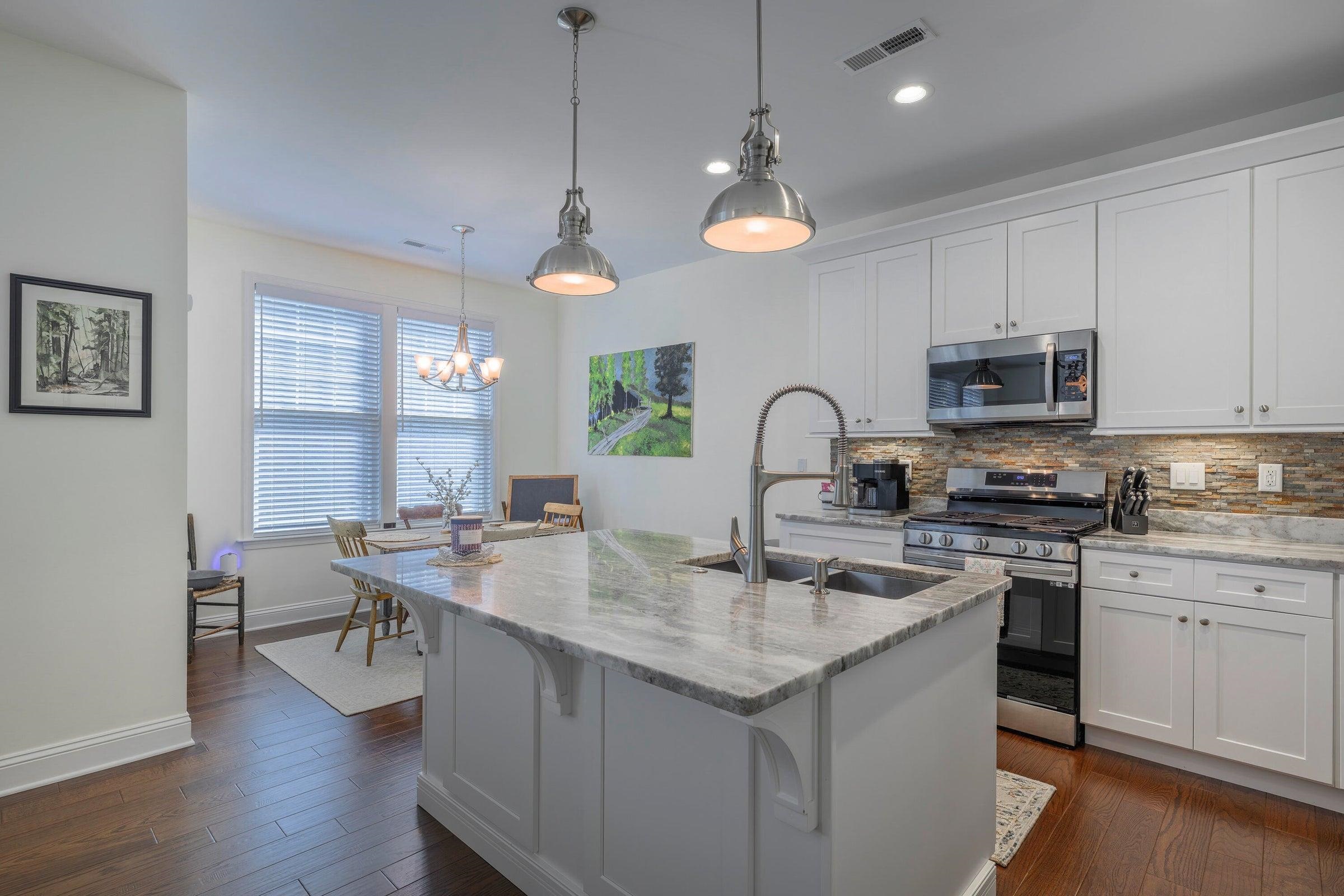 Kitchen features granite countertops and stainless steel appliances.